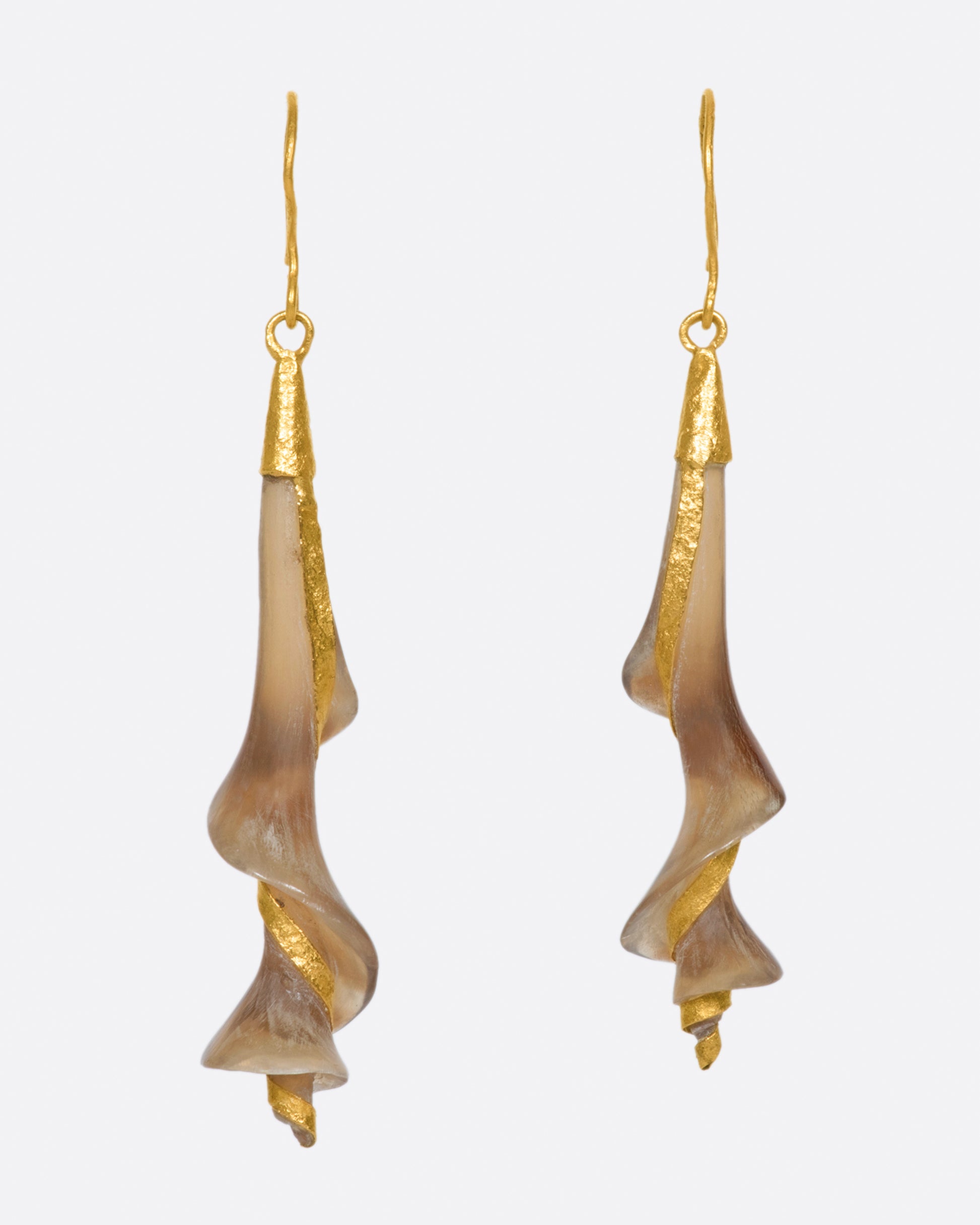 A pair of 22k yellow gold earrings with swirled brown horn drops.