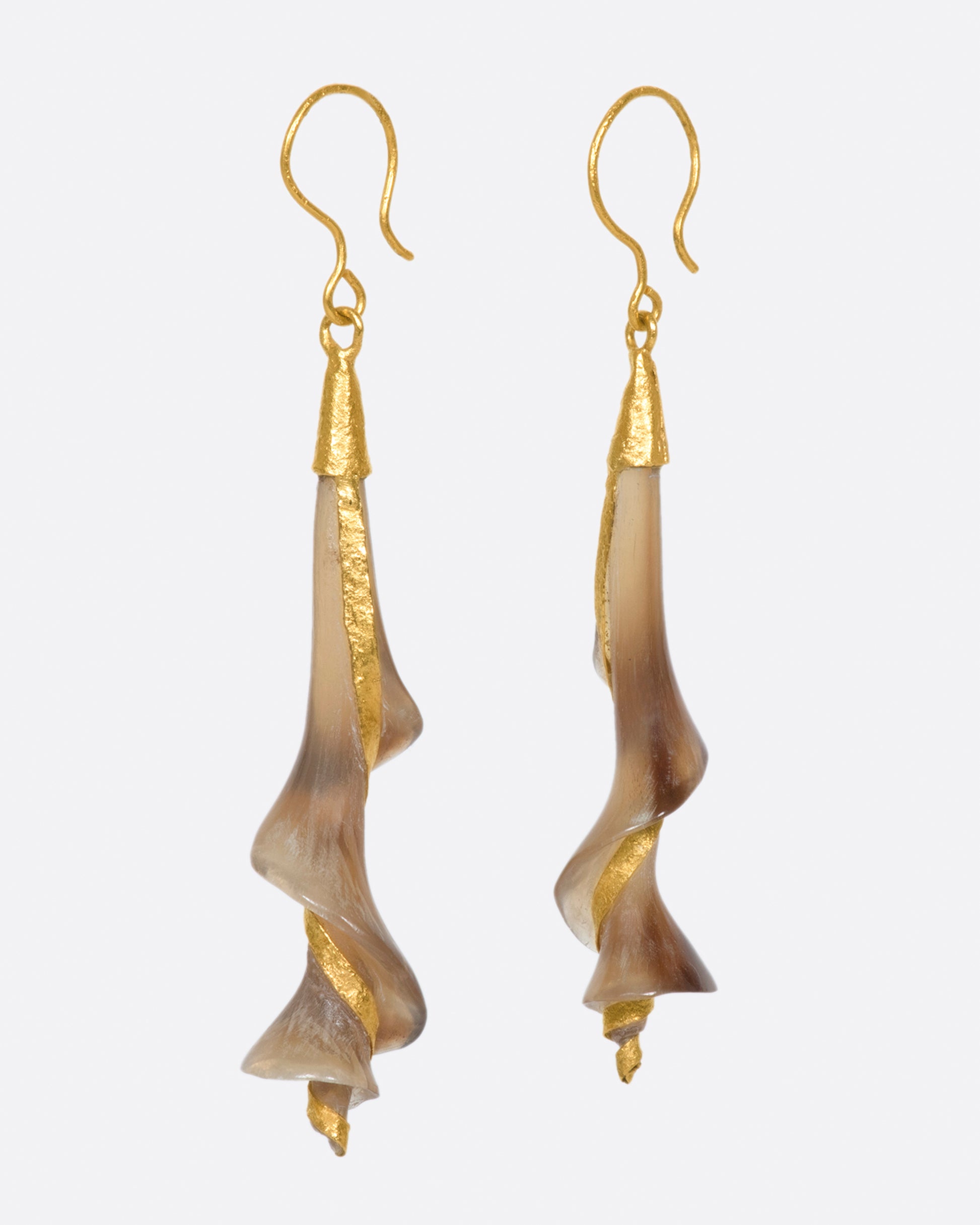 A pair of 22k yellow gold earrings with swirled brown horn drops.