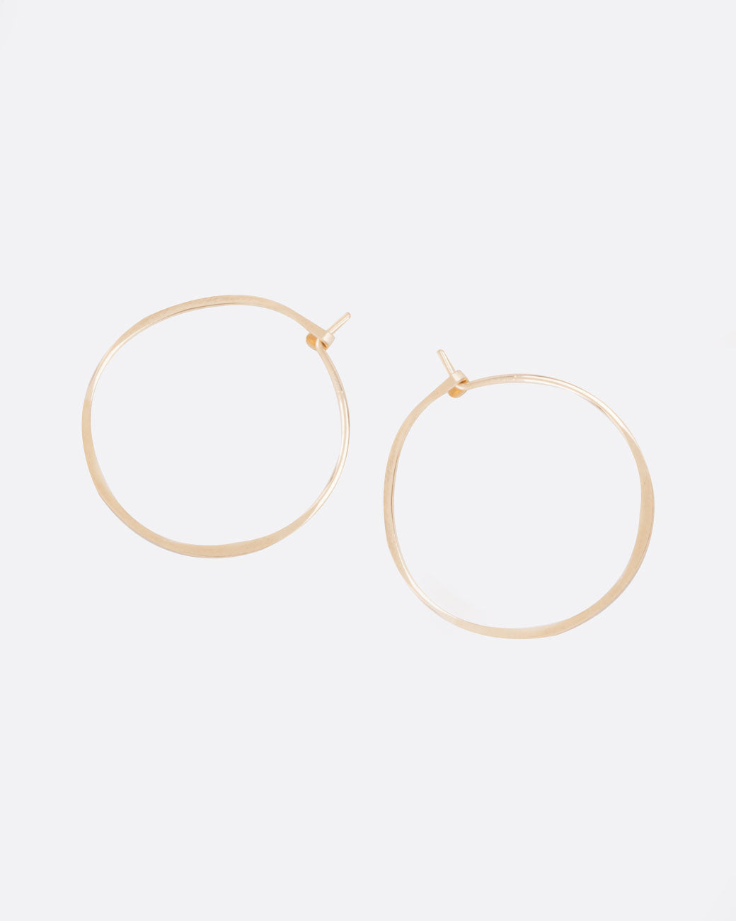 A pair of fairmined gold, hand-hammered hoops that close upon themselves.