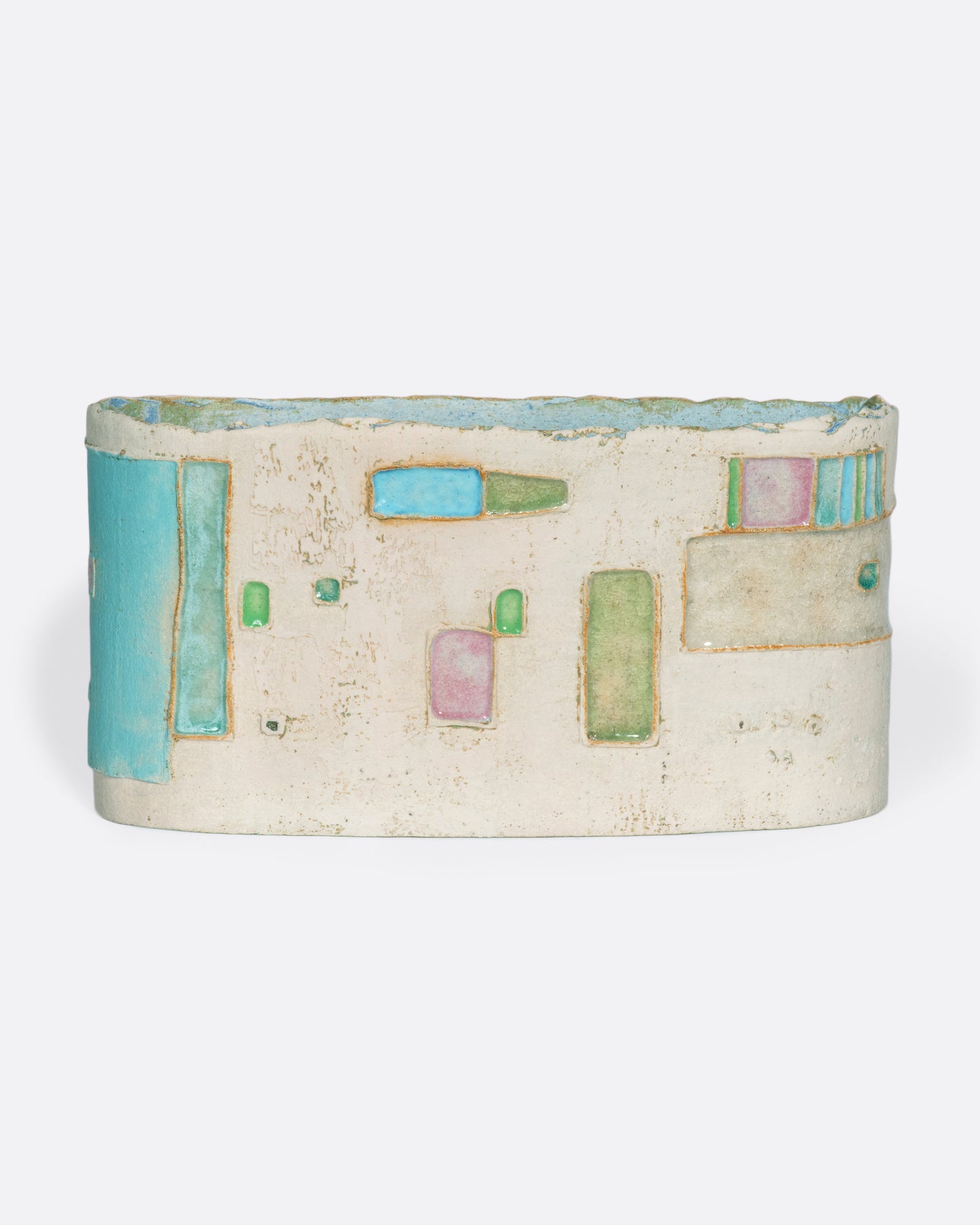 A ceramic vessel meticulously handmade with many layers of glaze atop stoneware clay. The rich, varied texture becomes a beautiful canvas for a dreamy slice of a sun-drenched town in Greece.