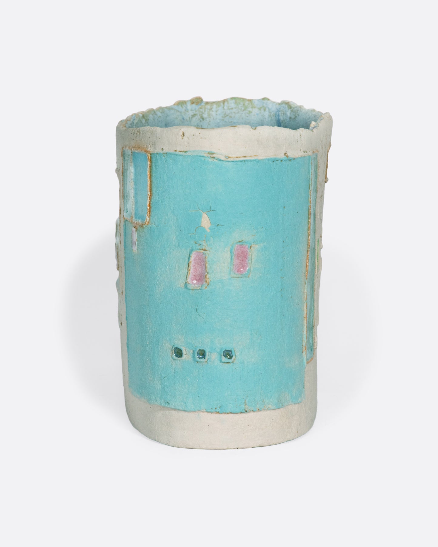 A ceramic vessel meticulously handmade with many layers of glaze atop stoneware clay. The rich, varied texture becomes a beautiful canvas for a dreamy slice of a sun-drenched town in Greece.