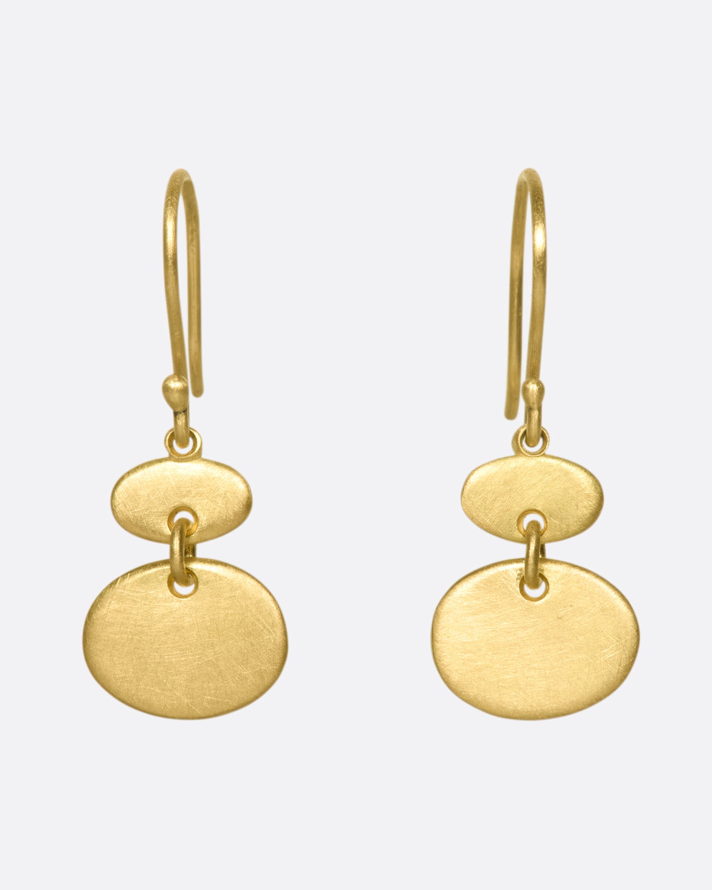A pair of matte gold sequin earrings with great movement.