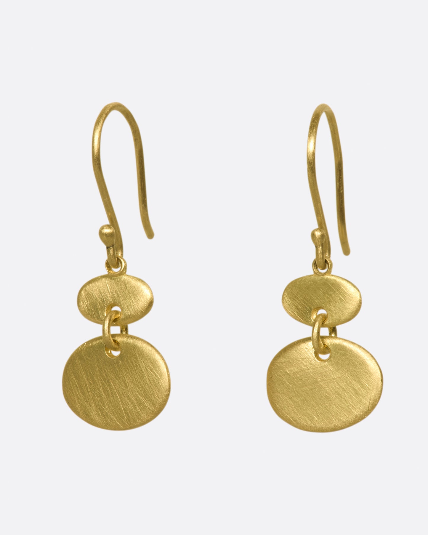A pair of matte gold sequin earrings with great movement.