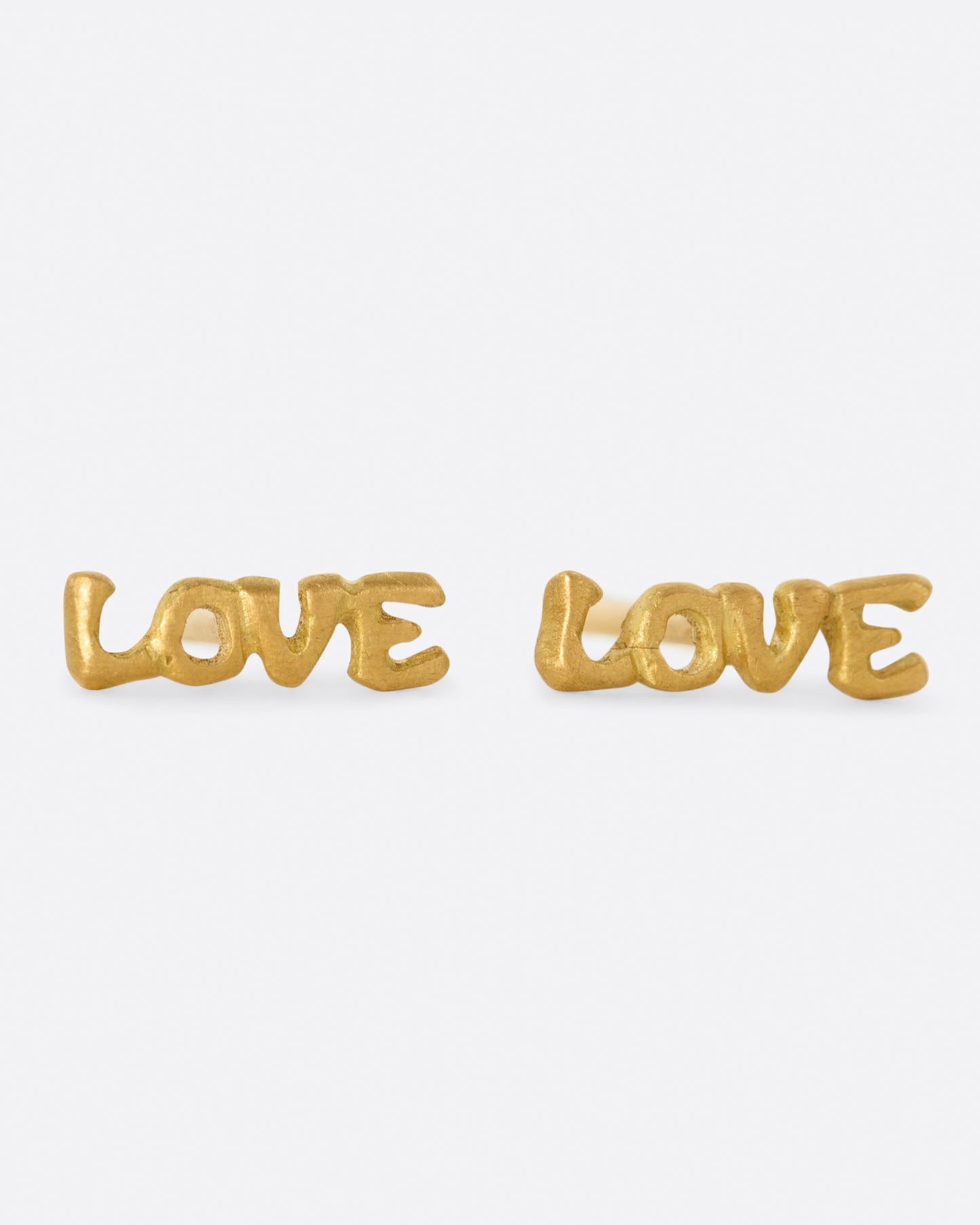 A pair of simple and sweet gold earrings. The word LOVE is spelt out, making these a great gift for your sweetheart.