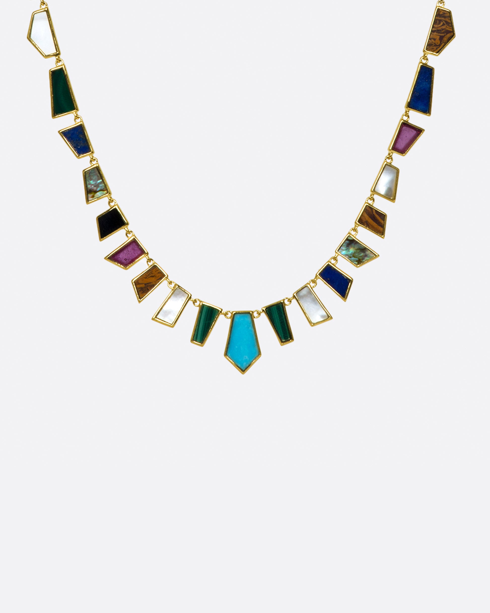 An exceptional array of geometric, hand-cut stones intricately laid in 9k gold. Look closely and, you'll notice the stones are symmetrically cut, while each color is different.