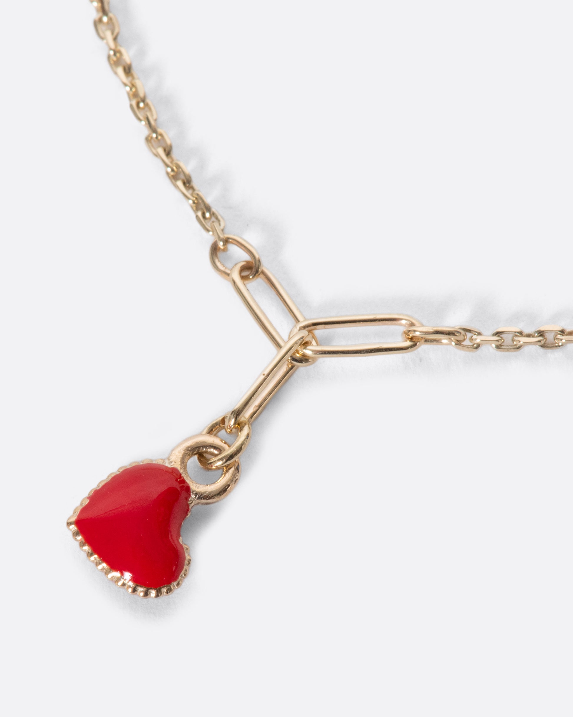 A precious candy apple red enamel heart on a fine gold chain bracelet