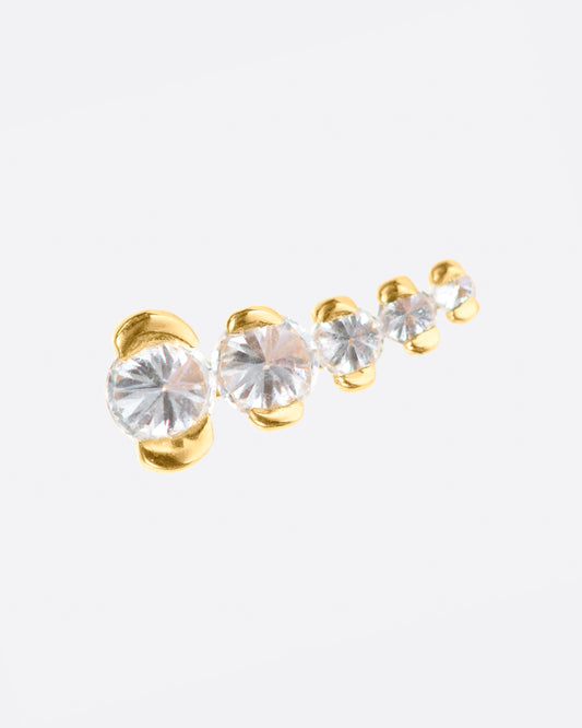 A gold stud with five inverted diamonds arranged in a slight curve.