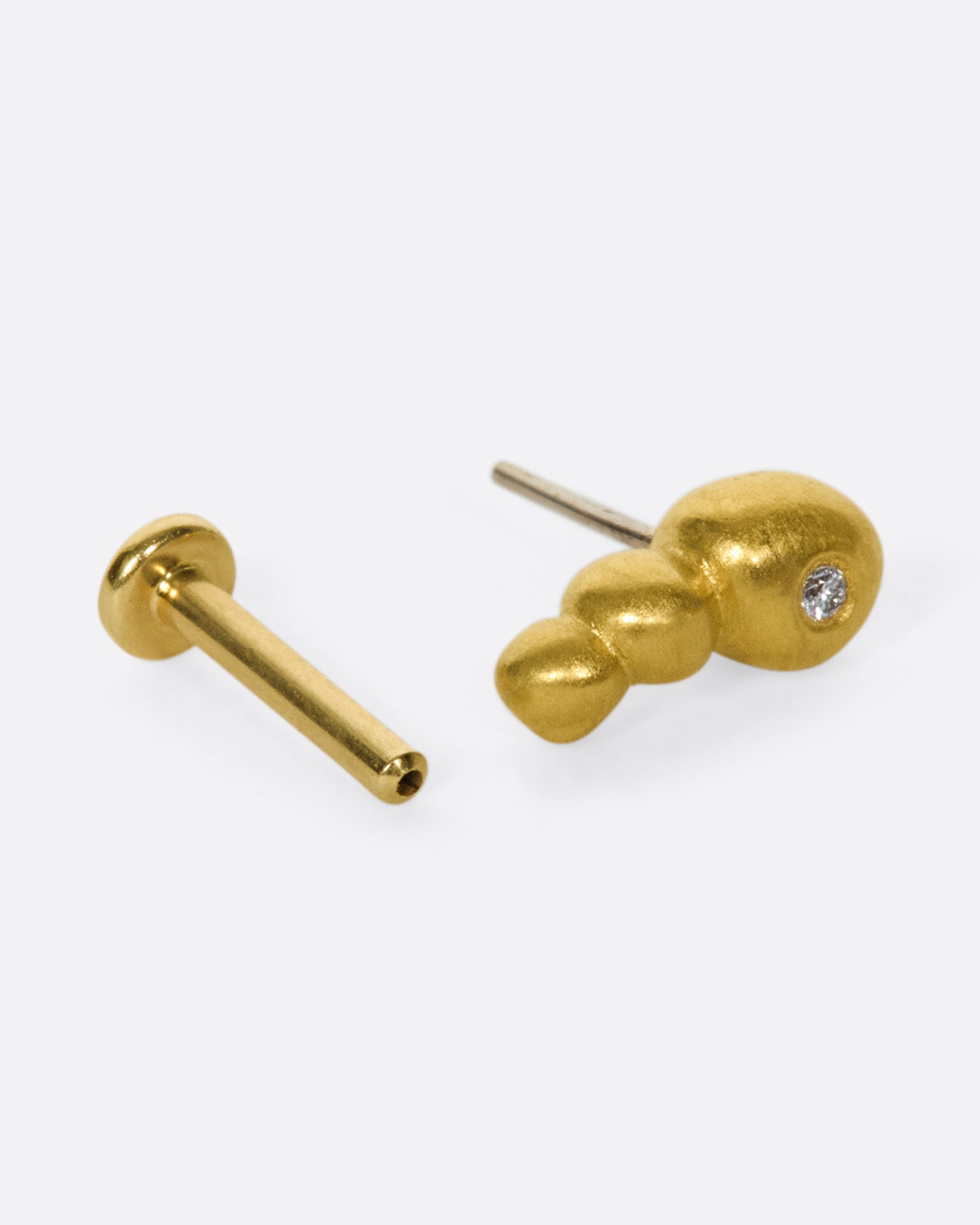 This high karat gold stud is perfect to tuck into little curves in the ear.