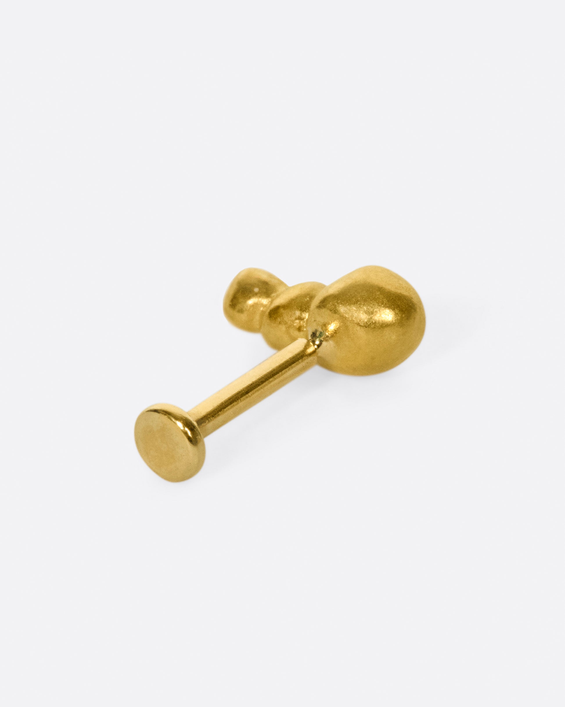 This high karat gold stud is perfect to tuck into little curves in the ear.