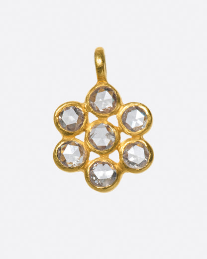 18k yellow gold cluster charm, seven bezel-set diamonds arranged like a flower, on a gold bail