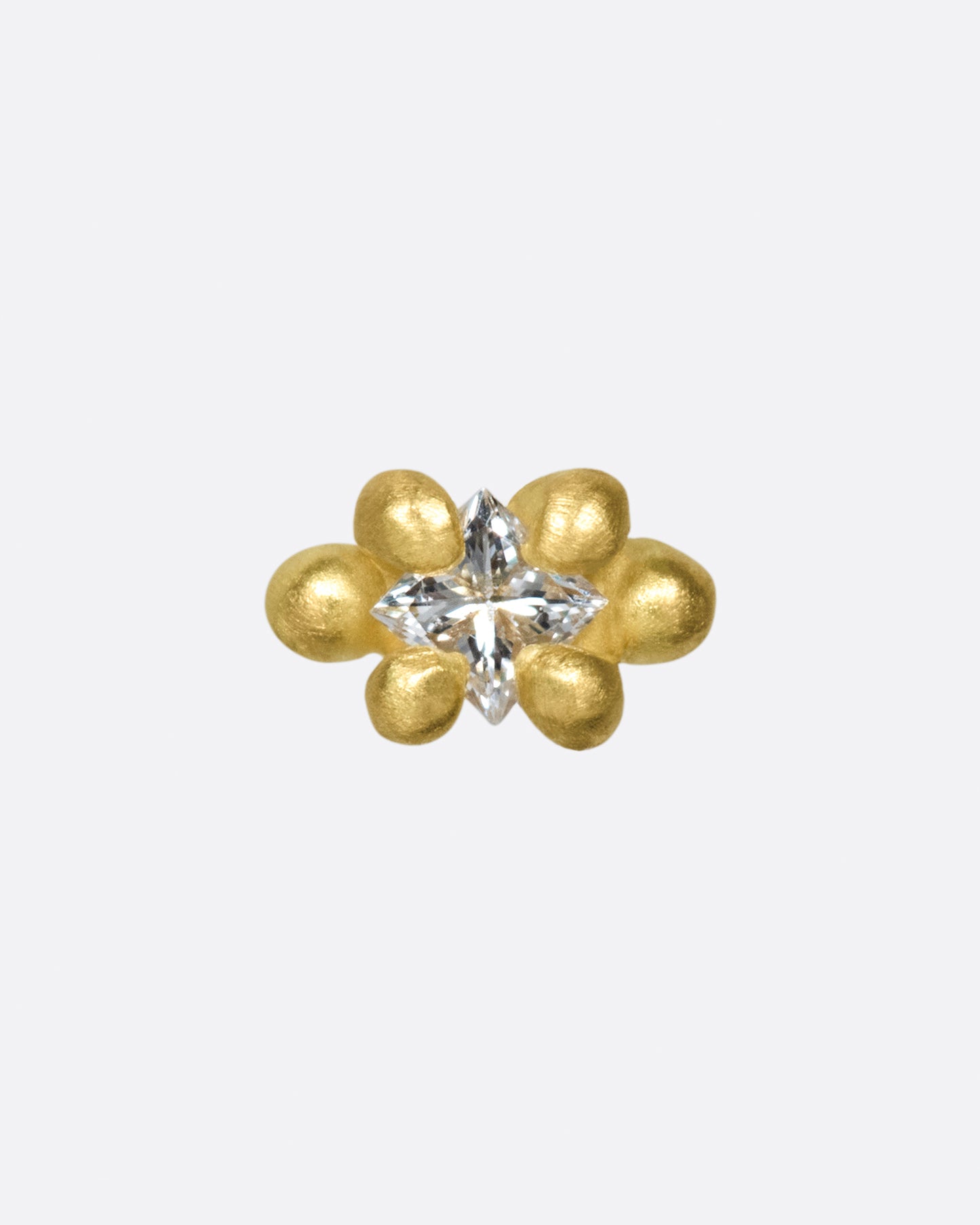 This solitaire stud's matte gold prongs make it more substantial, while remaining soft looking.