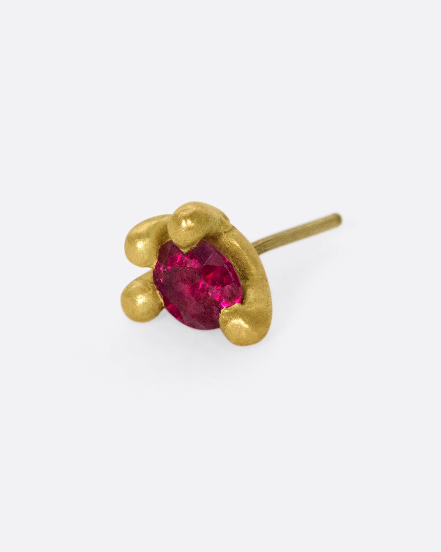 This earring is really about the ruby; large and saturated, it's a statement in itself.