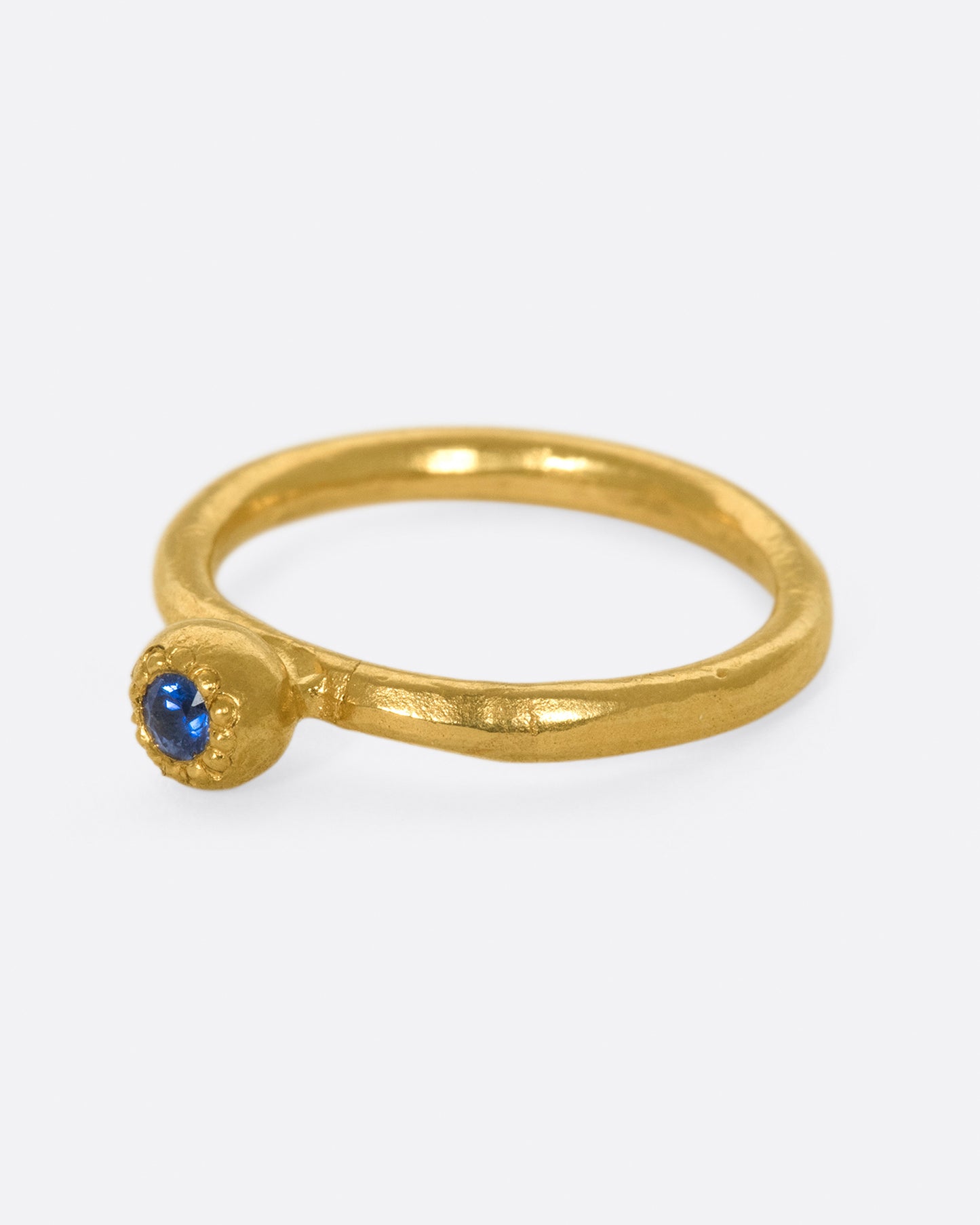 A deep blue sapphire solitaire ring; perfect on its own or stacked with its emerald counterpart.