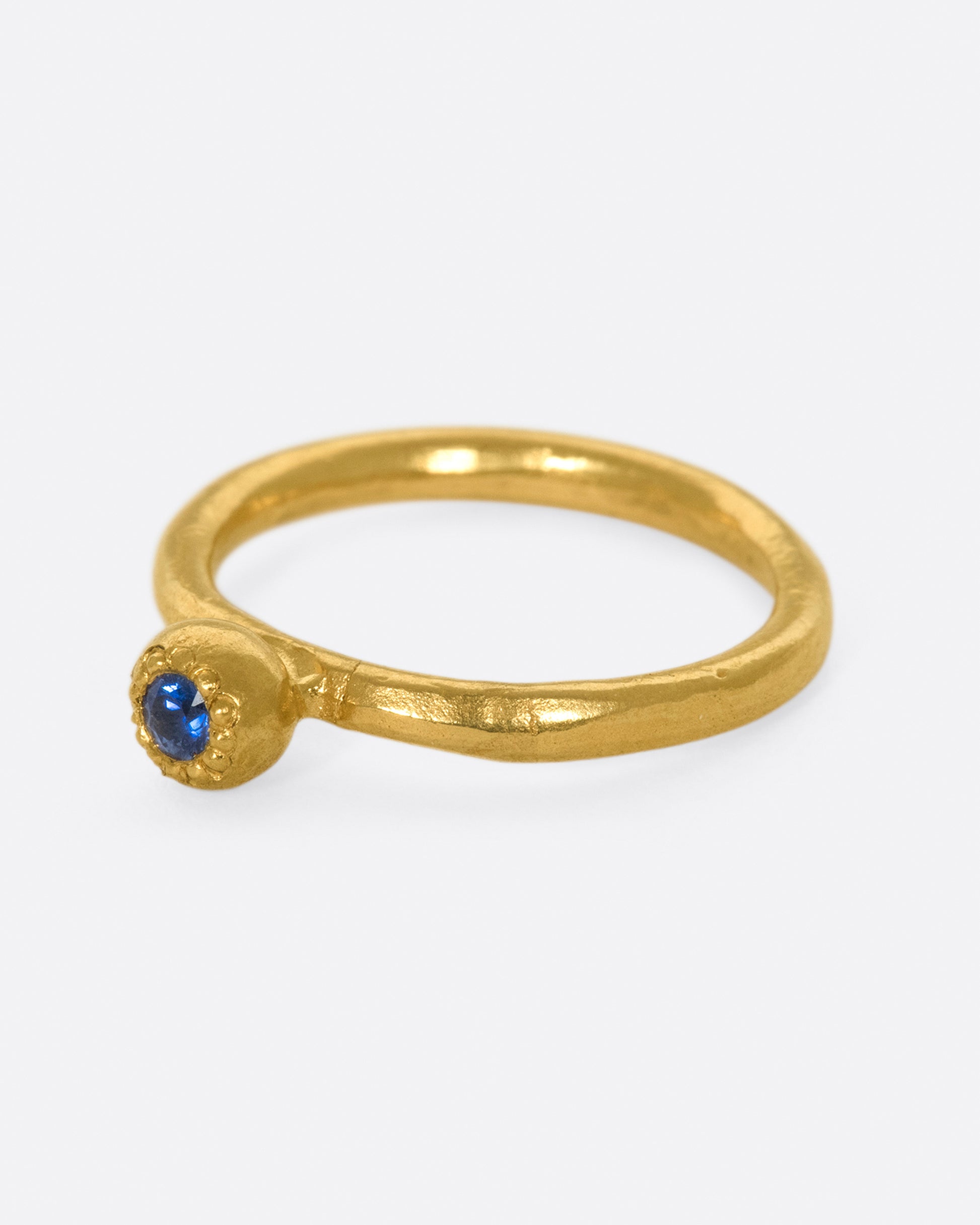 A deep blue sapphire solitaire ring; perfect on its own or stacked with its emerald counterpart.