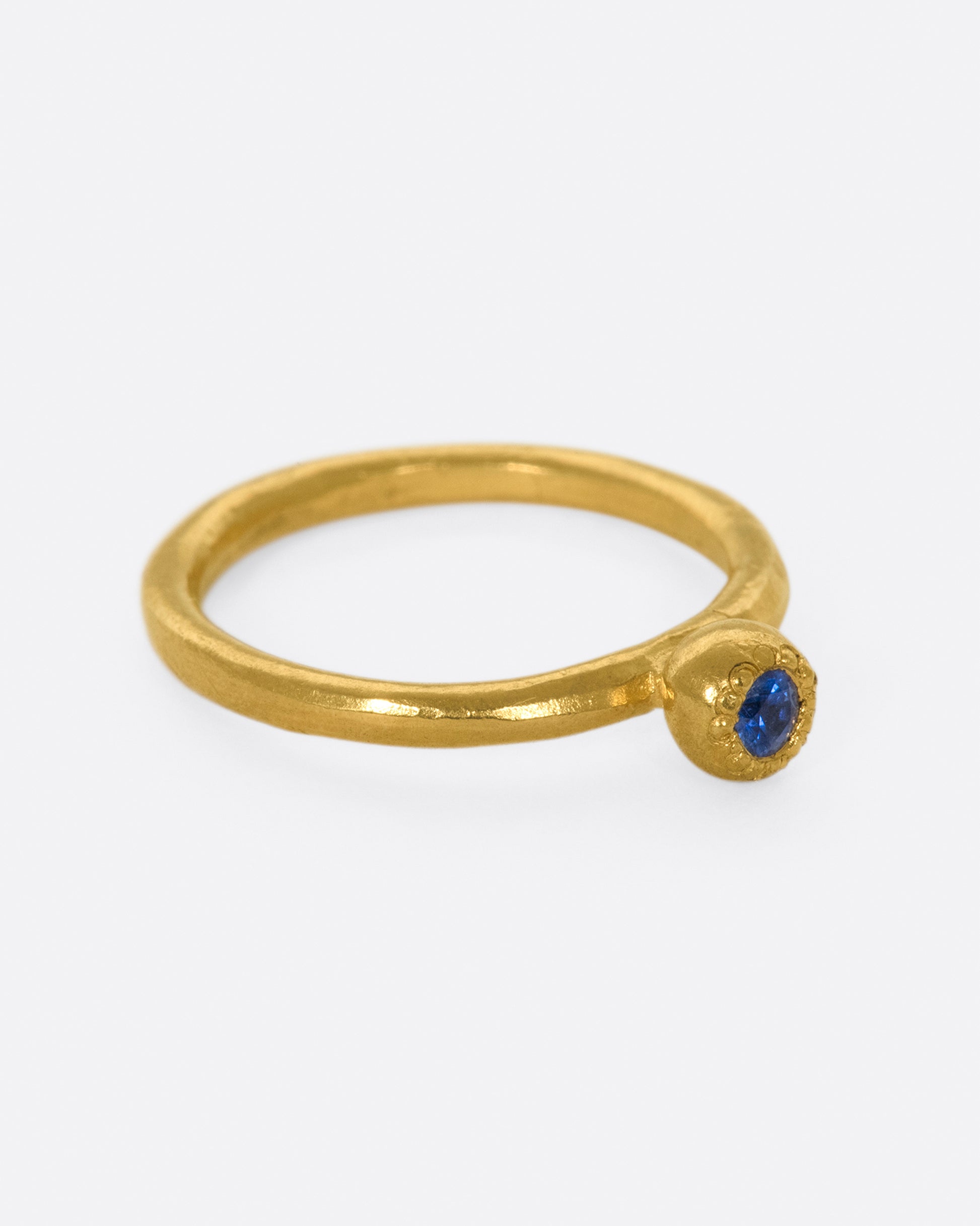 A deep blue sapphire solitaire ring; perfect on its own or stacked with its emerald counterpart.