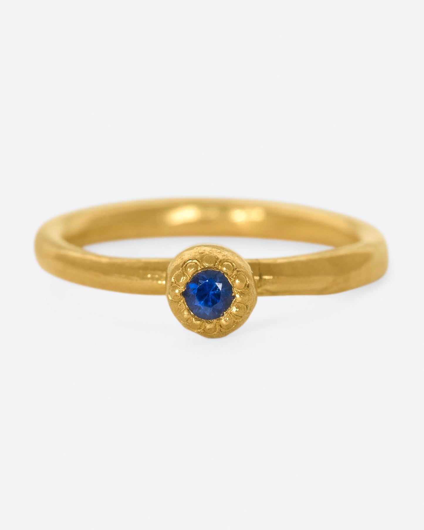 A deep blue sapphire solitaire ring; perfect on its own or stacked with its emerald counterpart.