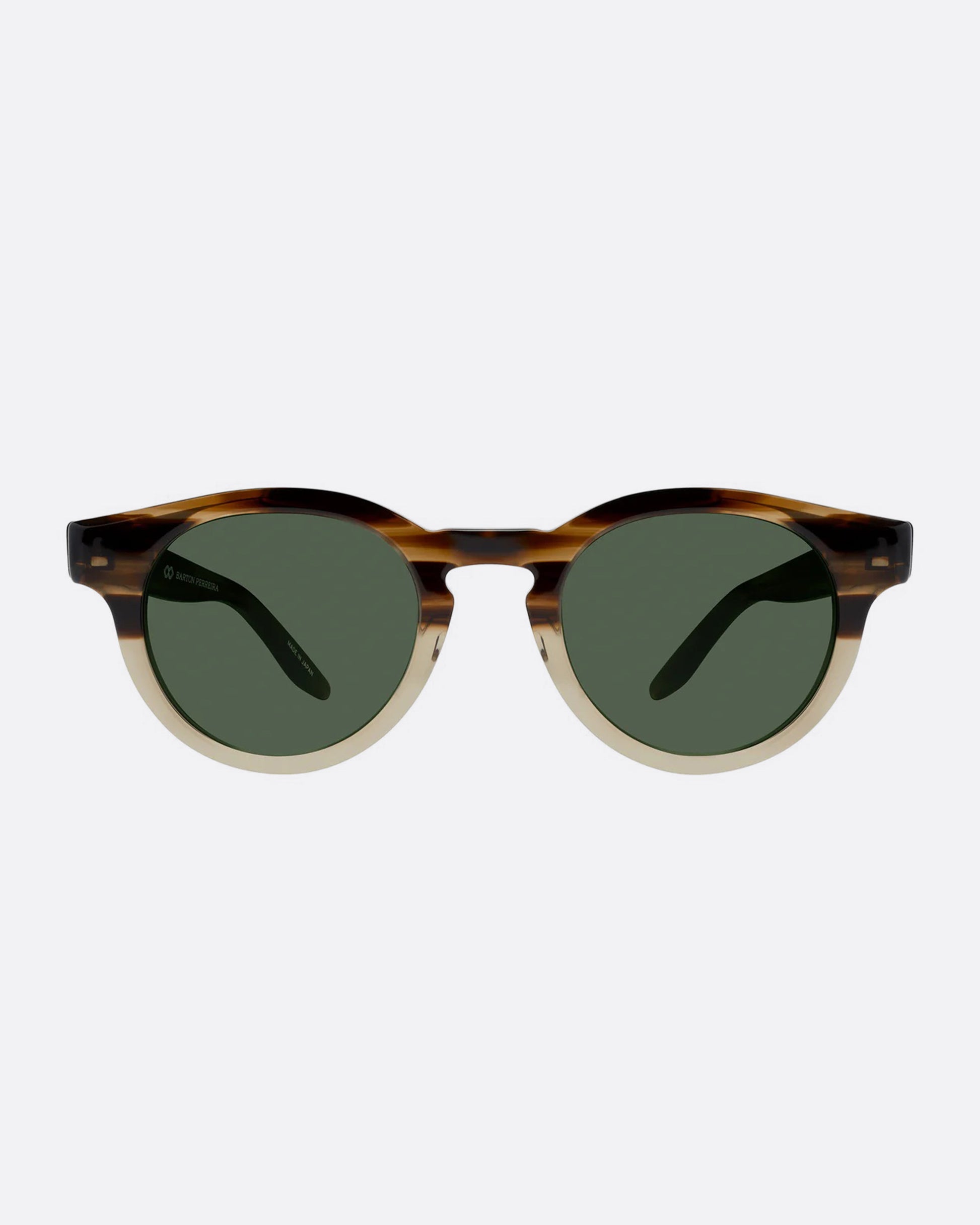 A round pair of sunglasses with frames that are brown on top and tan on the bottom. The lenses are dark green. Shown from the front.  