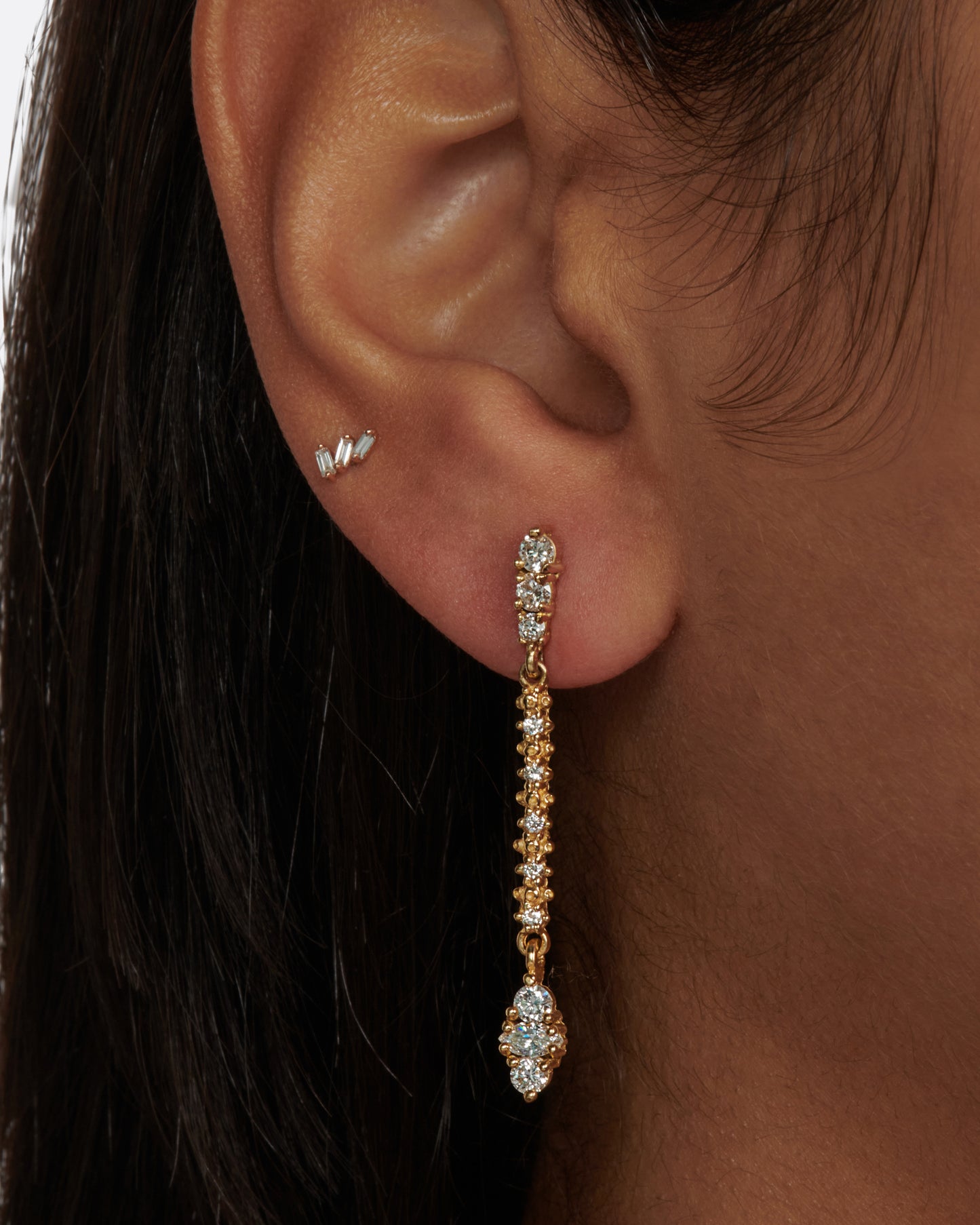 A pair of classic stud earrings with textured round and marquise diamond drops.