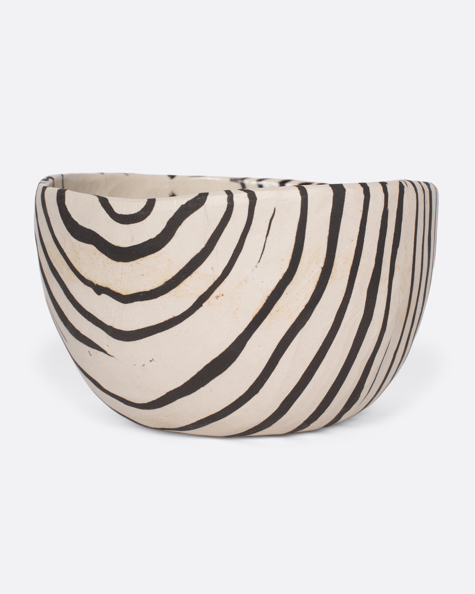 These small-batch ceramic bowls are made with a traditional Japanese Nerikomi technique that creates an intricate, marbled design by layering and compressing clay. Each bowl has a unique, zebra-striped design that feels other-worldly and timeless. Available in small, medium, and large sizes.