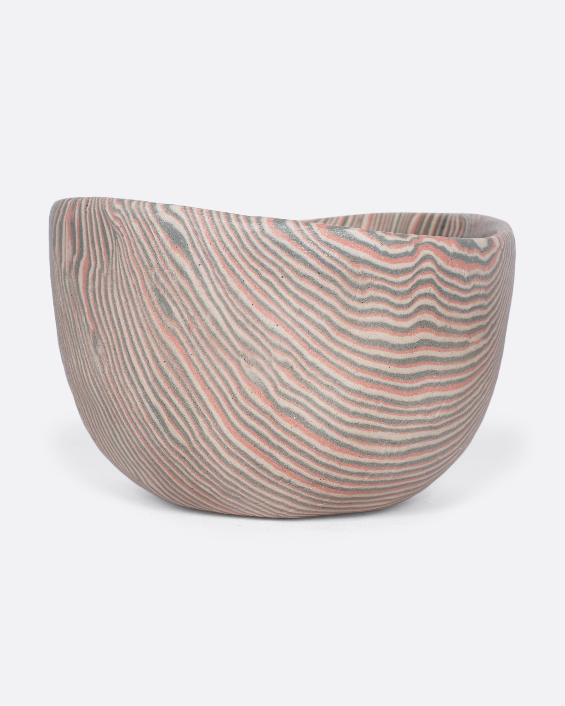 These small-batch ceramic bowls are made with a traditional Japanese nerikomi technique that creates an intricate, marbled design by layering and compressing clay. This timeless style feels plucked from desert sandstone with flowing hues of pink, white, and grey. Available in small, medium, and large sizes.