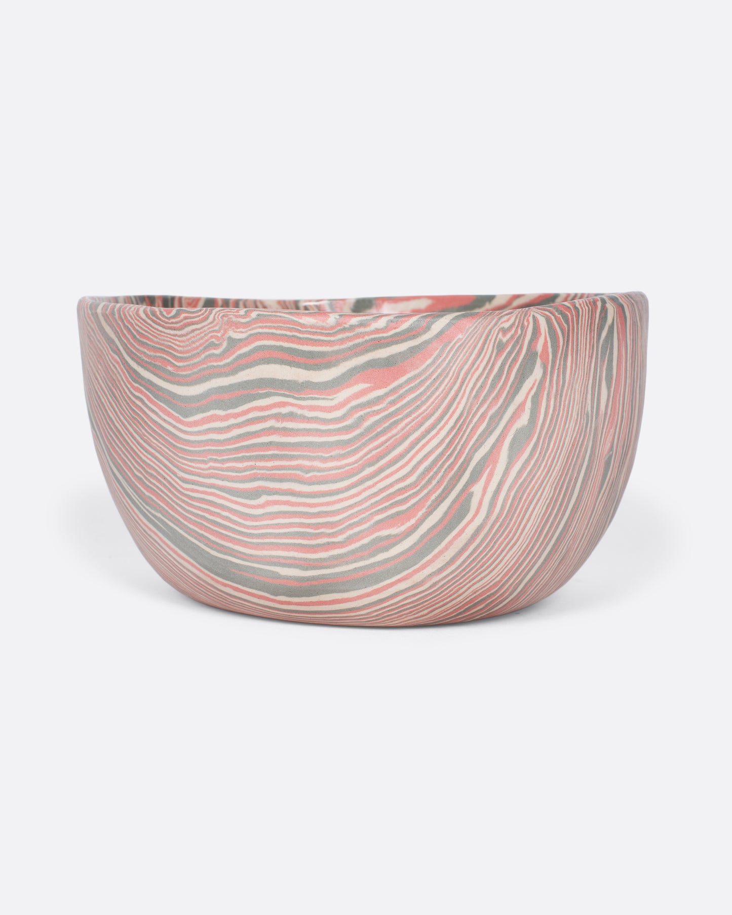 These small-batch ceramic bowls are made with a traditional Japanese nerikomi technique that creates an intricate, marbled design by layering and compressing clay. This timeless style feels plucked from desert sandstone with flowing hues of pink, white, and grey. Available in small, medium, and large sizes.