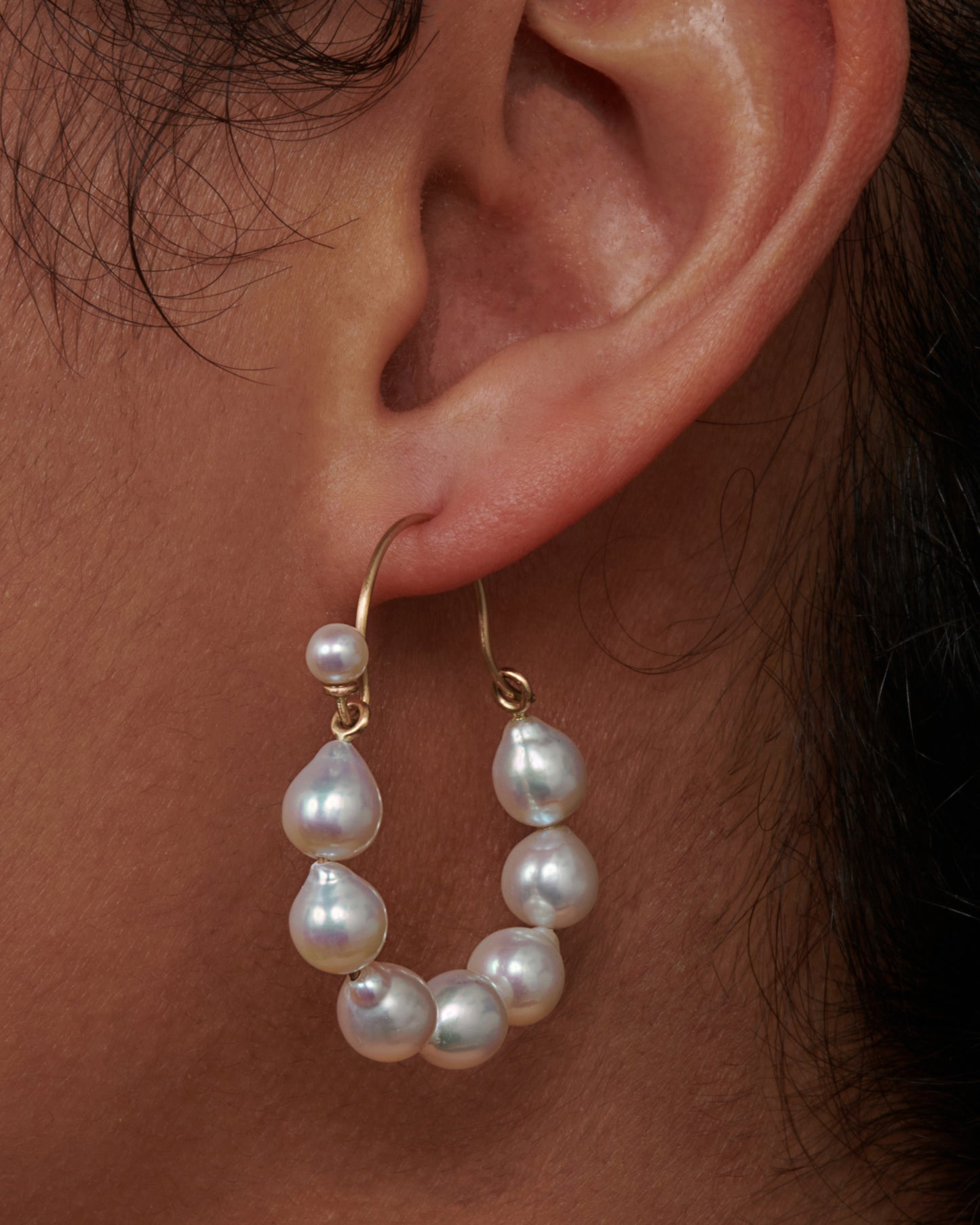 A lovely pair of baroque pearl hoops with a tiny pearl hiding the closure. View on an ear.