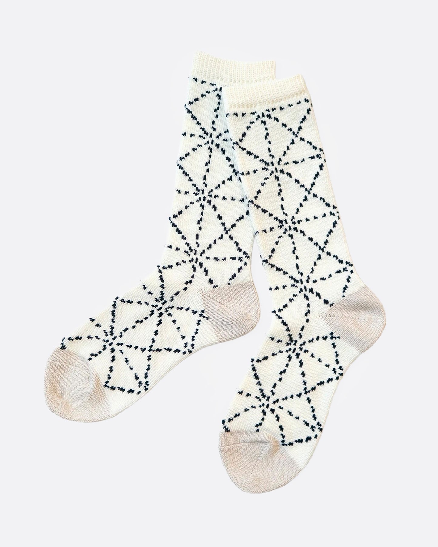 A pair of white socks with a Japanese sashiko print, shown from the side.