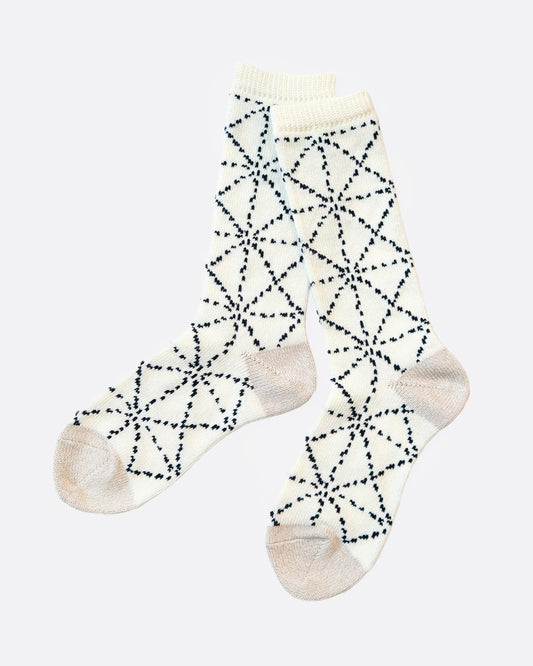 A pair of white socks with a Japanese sashiko print, shown from the side.