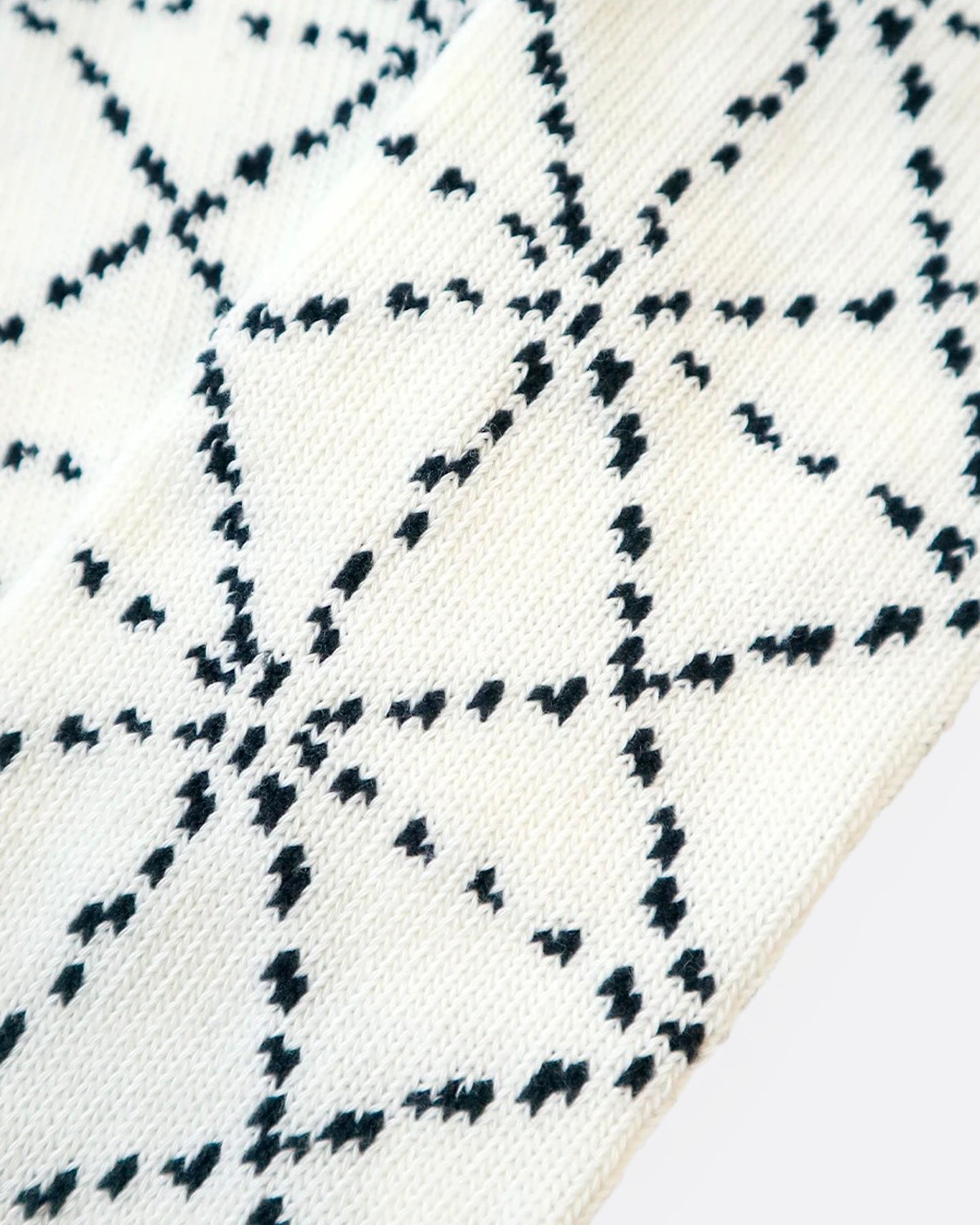 A close up of a white sock with a Japanese sashiko print.
