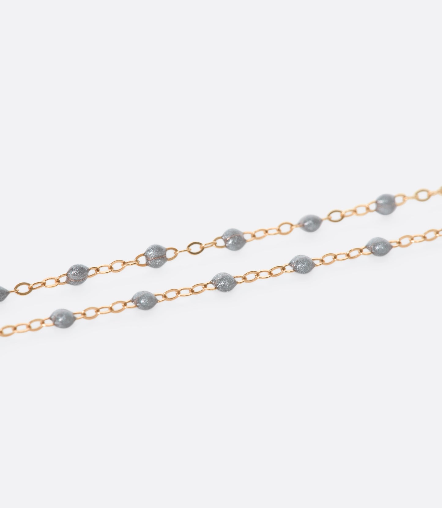 A thin yellow gold chain necklace with resin beads. Each necklace is hand dipped in melted resin to create the beaded effect. 