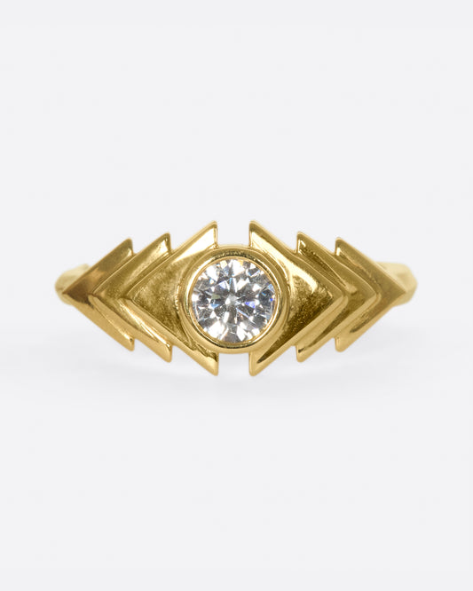 This ring takes cues from tribal kilim pieces, featuring a round diamond contrasting with a repetitive triangular motif