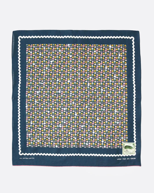 A navy blue bandana with a ditsy floral print and tiny skulls throughout, shown from the front.