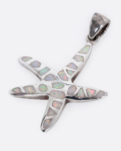 A silver starfish pendant with opal inlay show from the front.