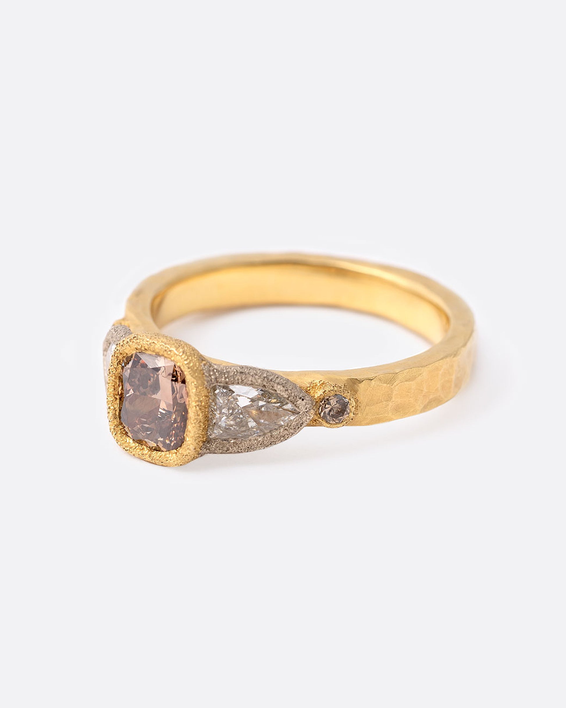 18k yellow gold ring with cushion cut brown diamond, two shield shaped white diamonds, and two round brown diamonds by Todd Pownell, shown from the side.