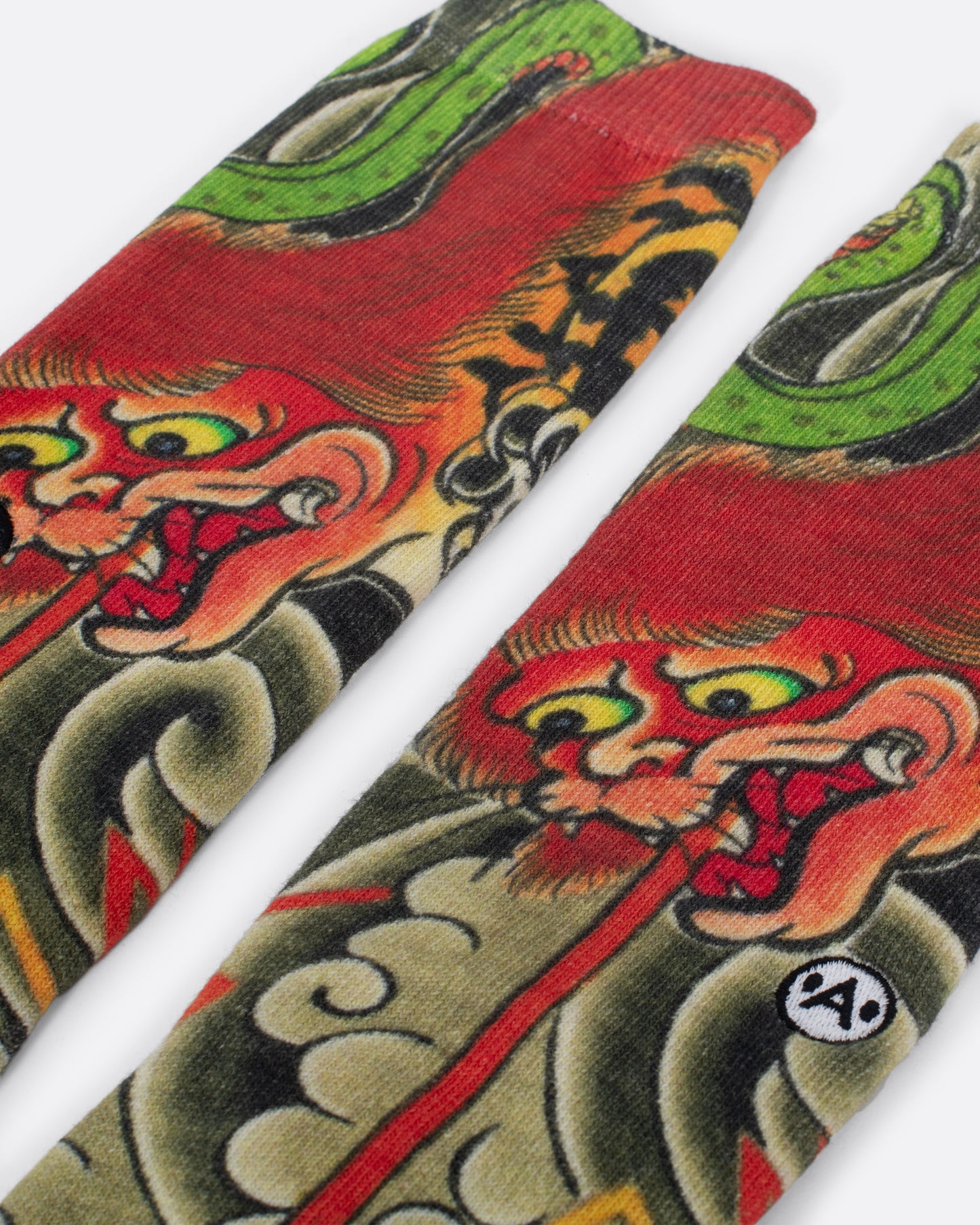 Socks with dragon spitting fire surrounded by smoke clouds. Close up view of dragon face.