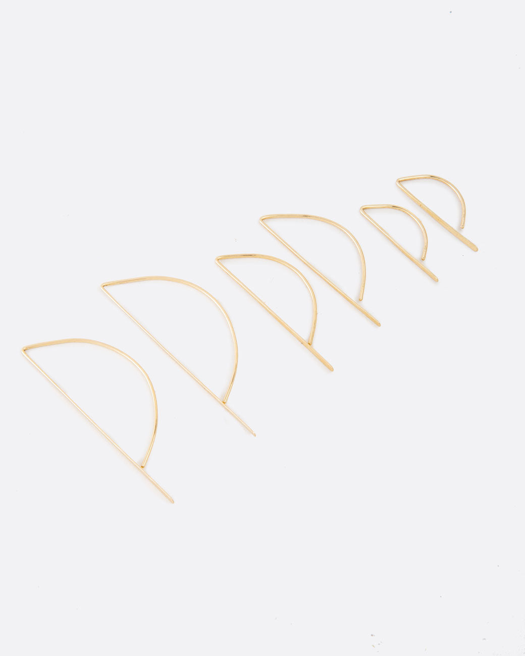 Called the bow hook earrings, this unusual shape is a unique take on a hoop earring with a flat edge that catches the light.