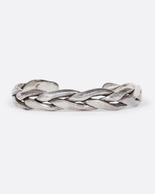 A vintage sterling silver cuff bracelet made from three braided strands of silver.