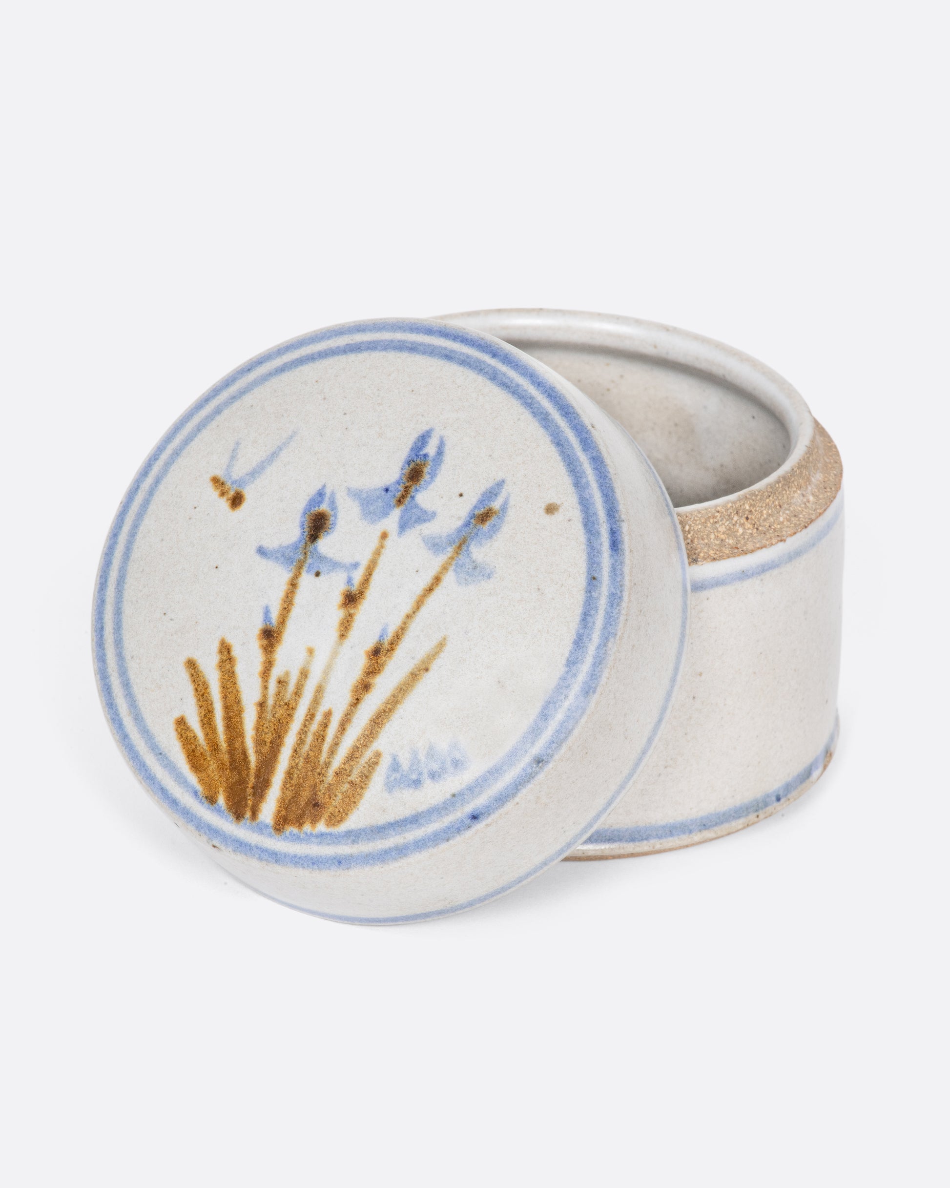 A sweet ceramic round box with blue irises hand painted on the lid.