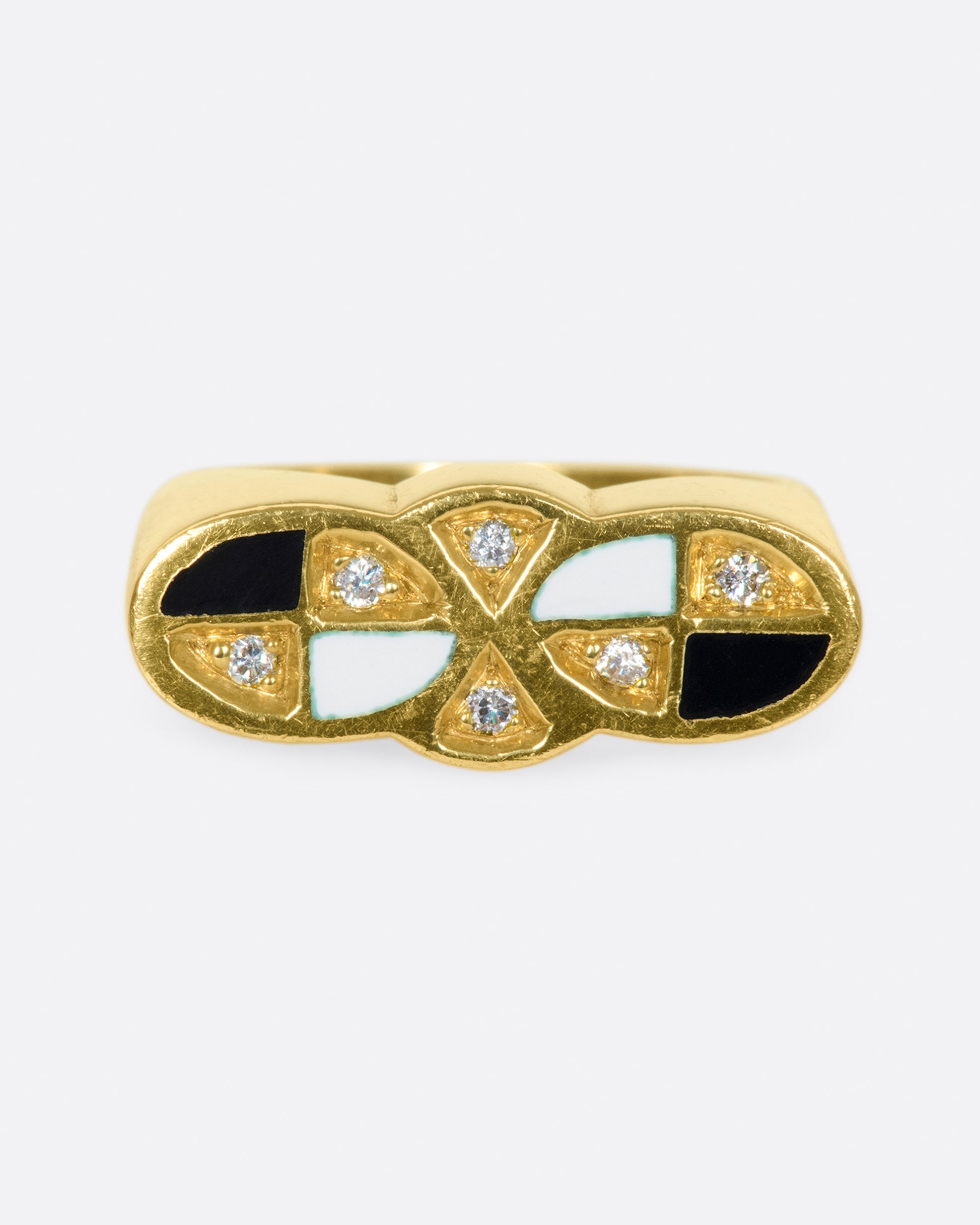 An 18k gold vintage double-oval ring with black and white checkered enamel and round diamond details