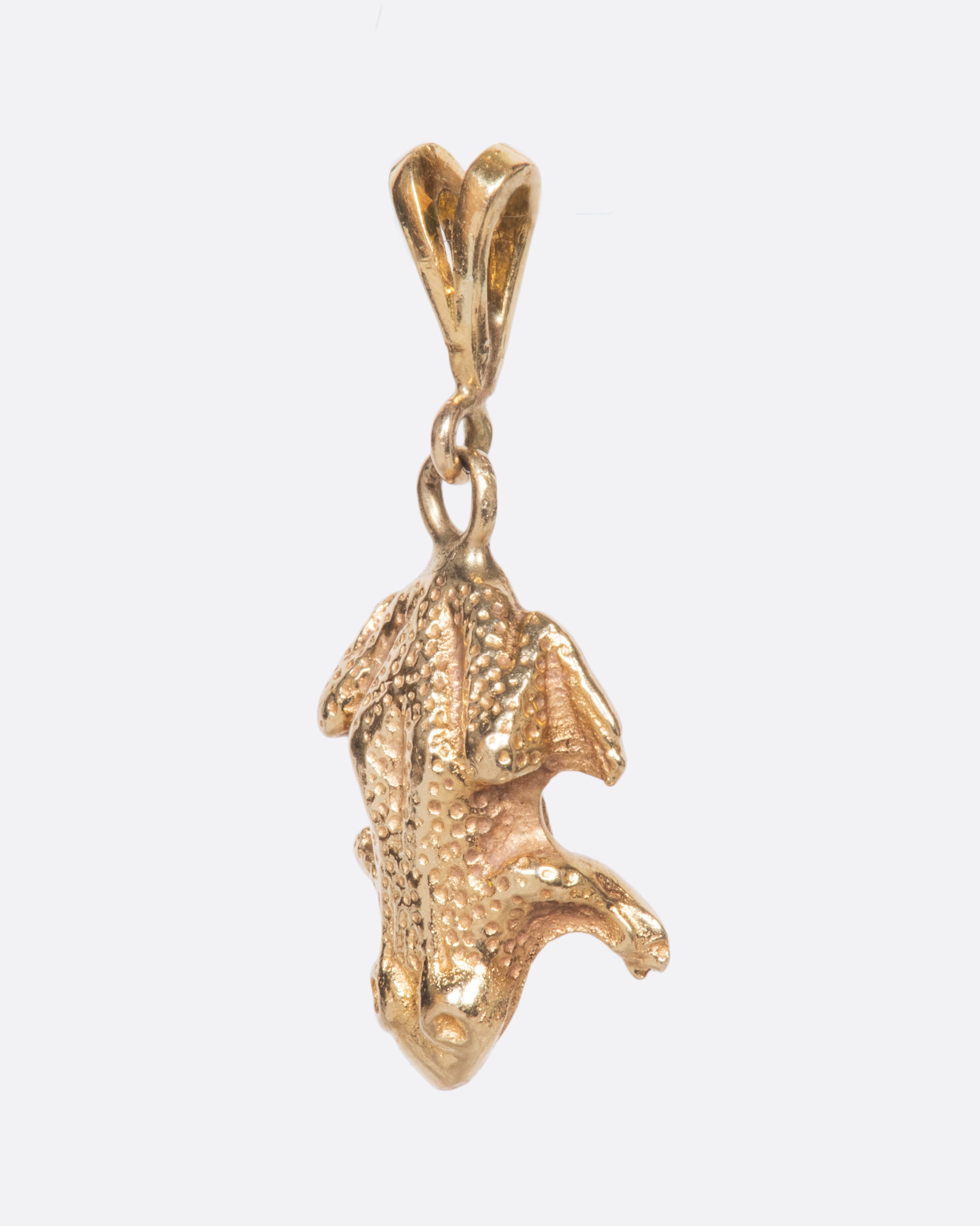 A yellow gold vintage frog charm with incredible detail and texture.