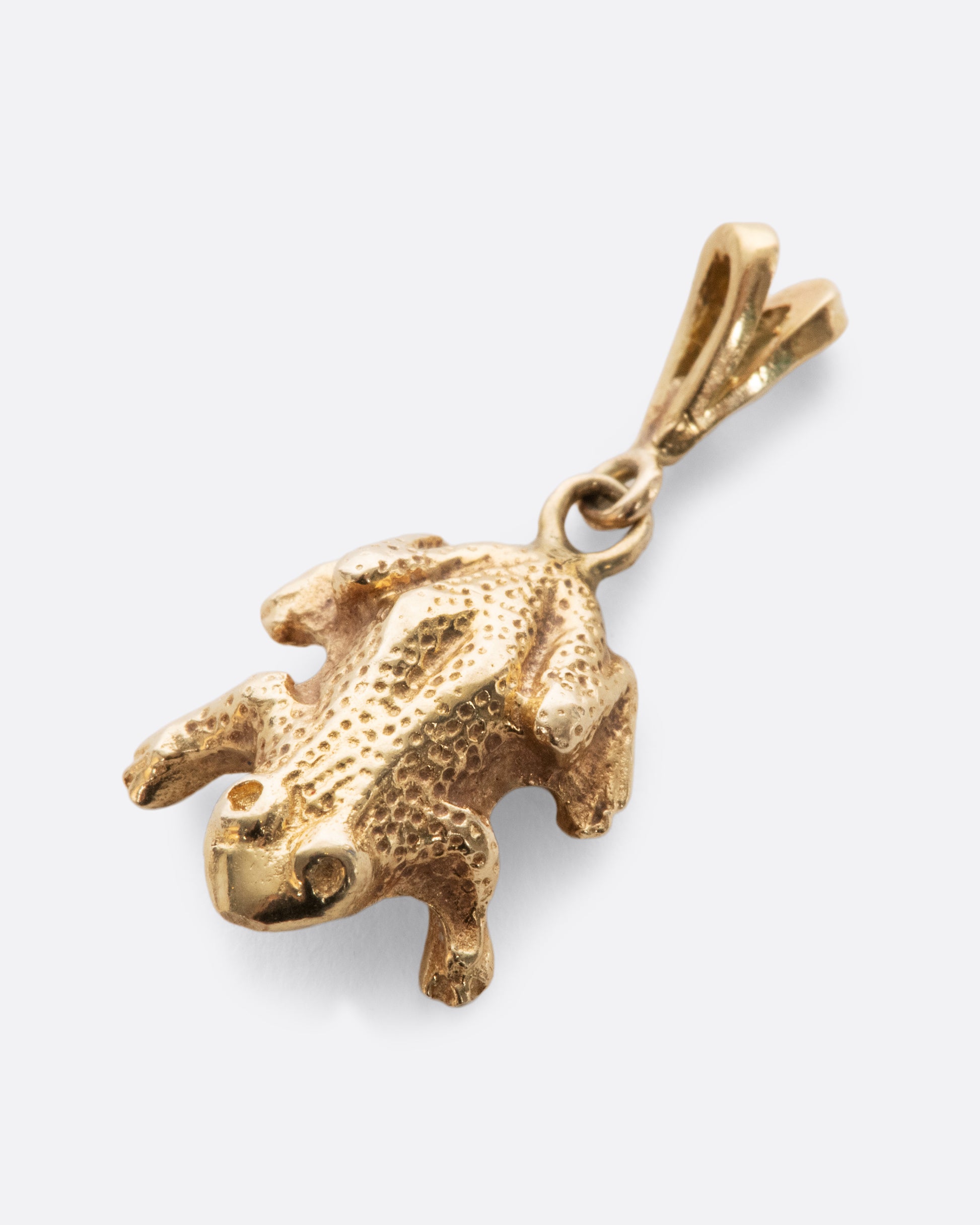 A yellow gold vintage frog charm with incredible detail and texture.