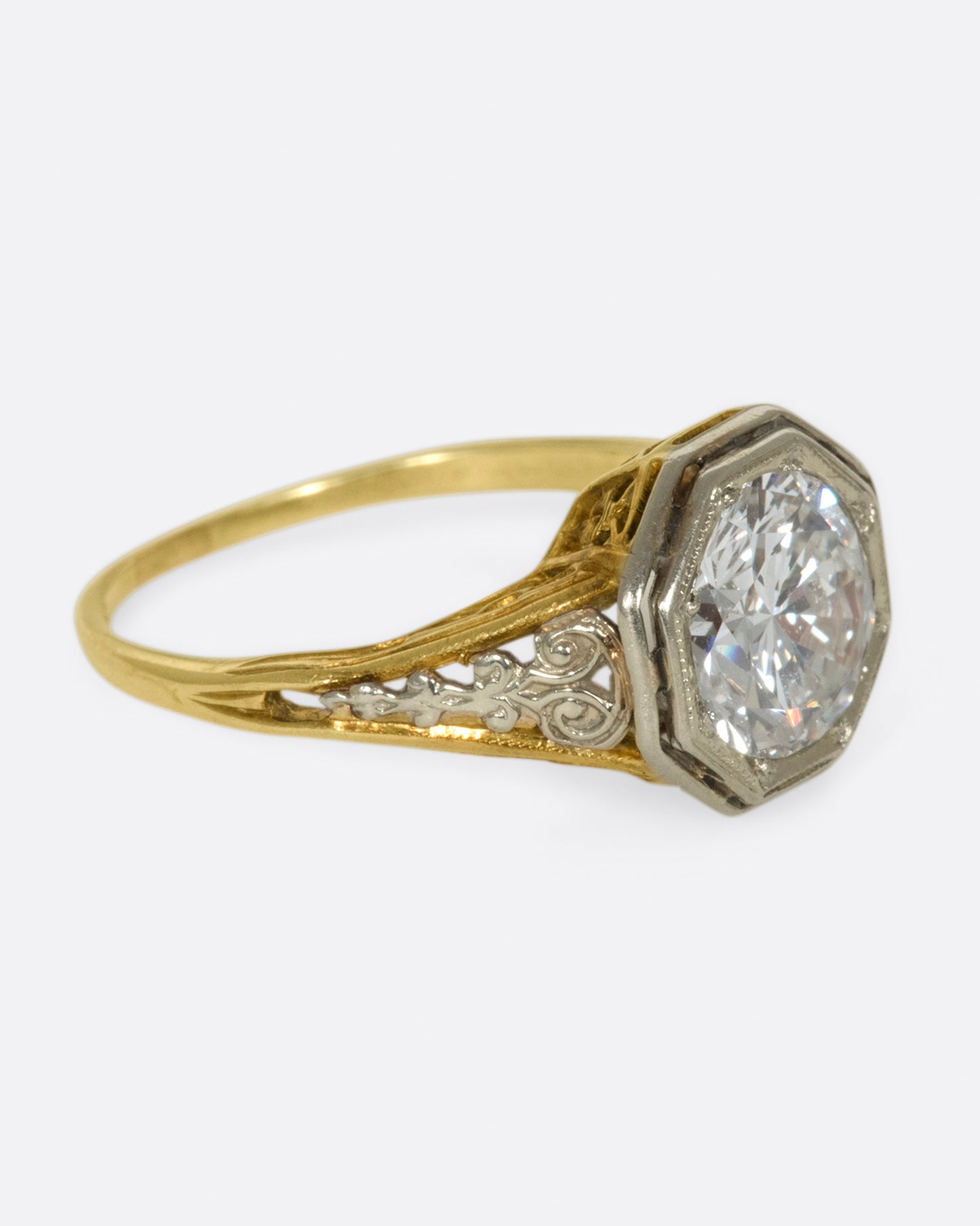 Mixed metals, intricate setting, large diamond; the ultimate vintage engagement ring.