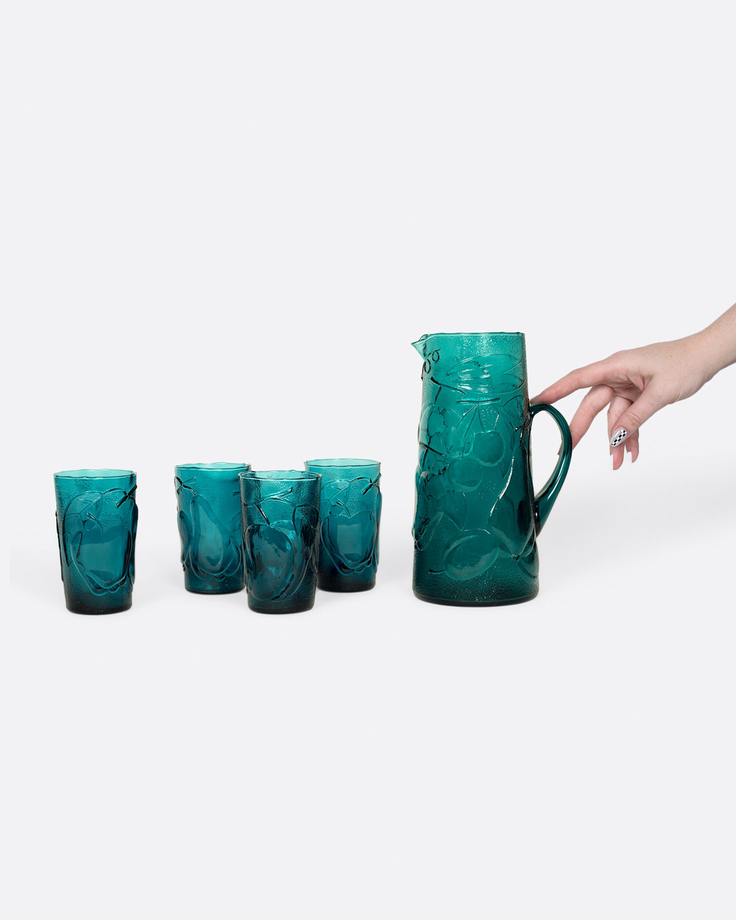 This teal glass set has a subtle fruity texture.