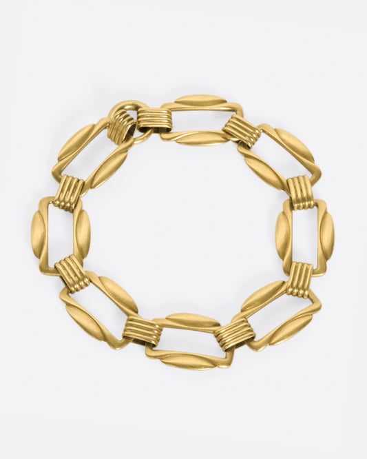 The clasp on this bracelet is hidden amongst its architectural links.