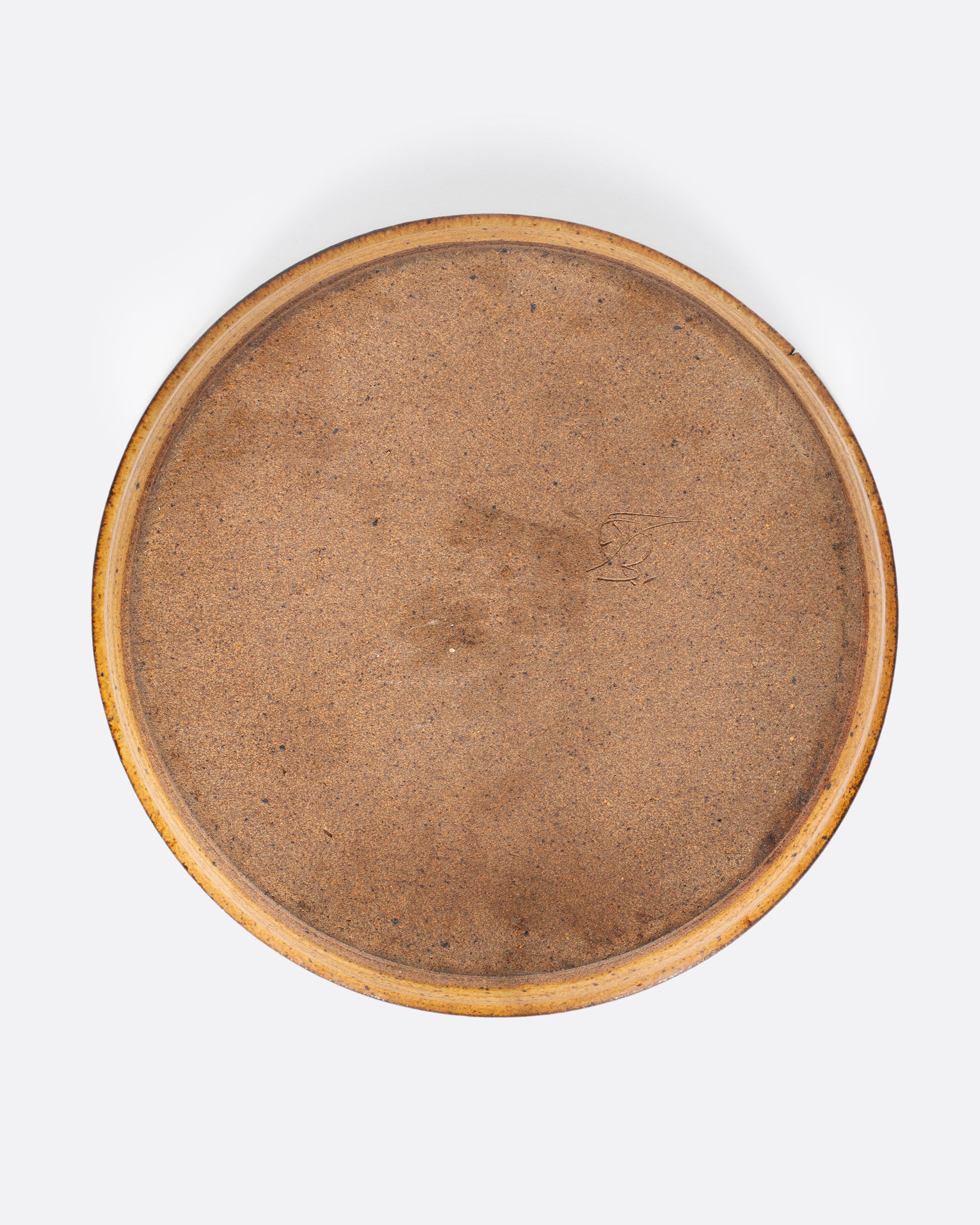 A vintage studio-made ceramic serving platter of generous size, with a swirling center design.