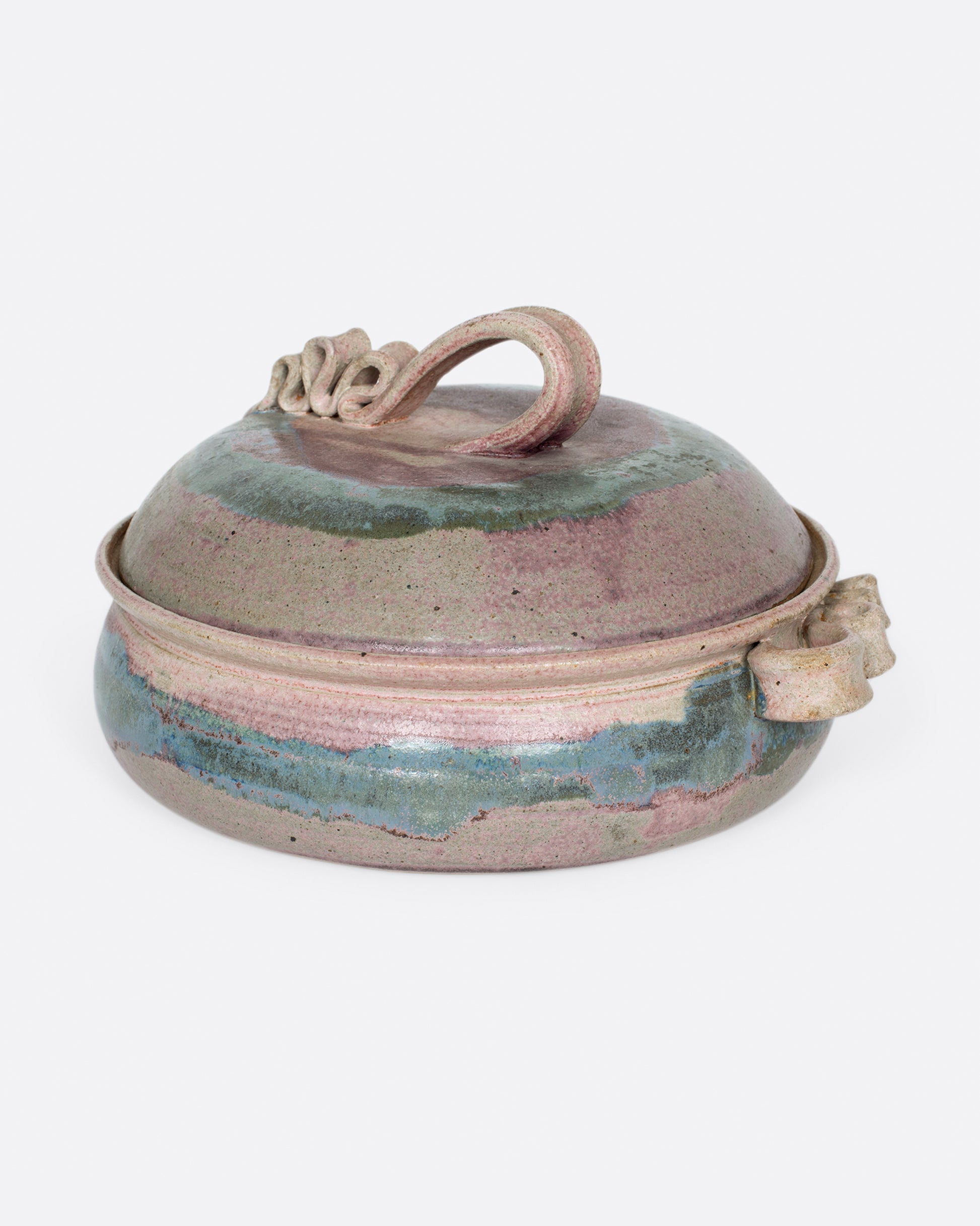 A painterly purple and green dish with ribbon-like handles.