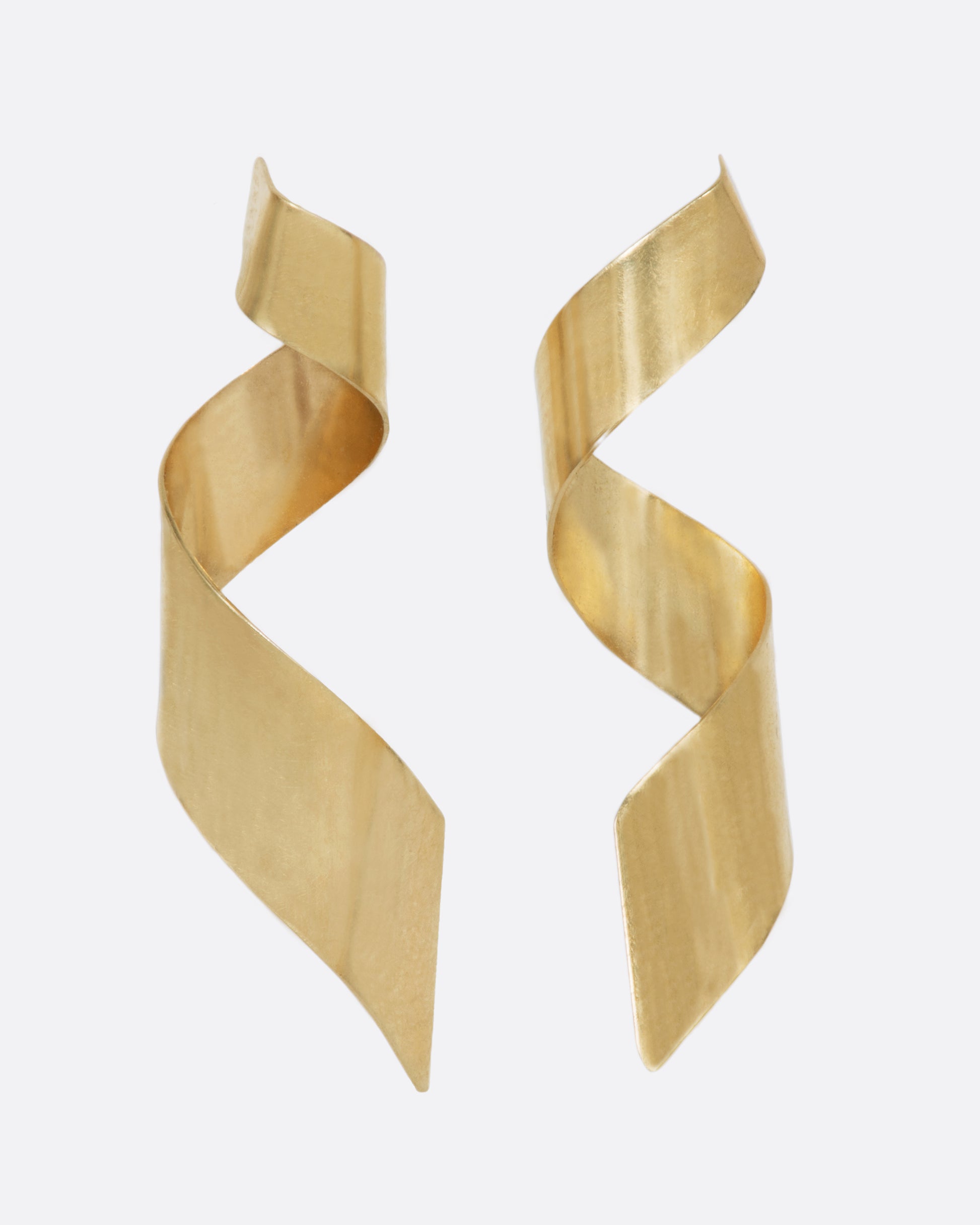 A pair of drop earrings made from 3D swirled gold ribbons.