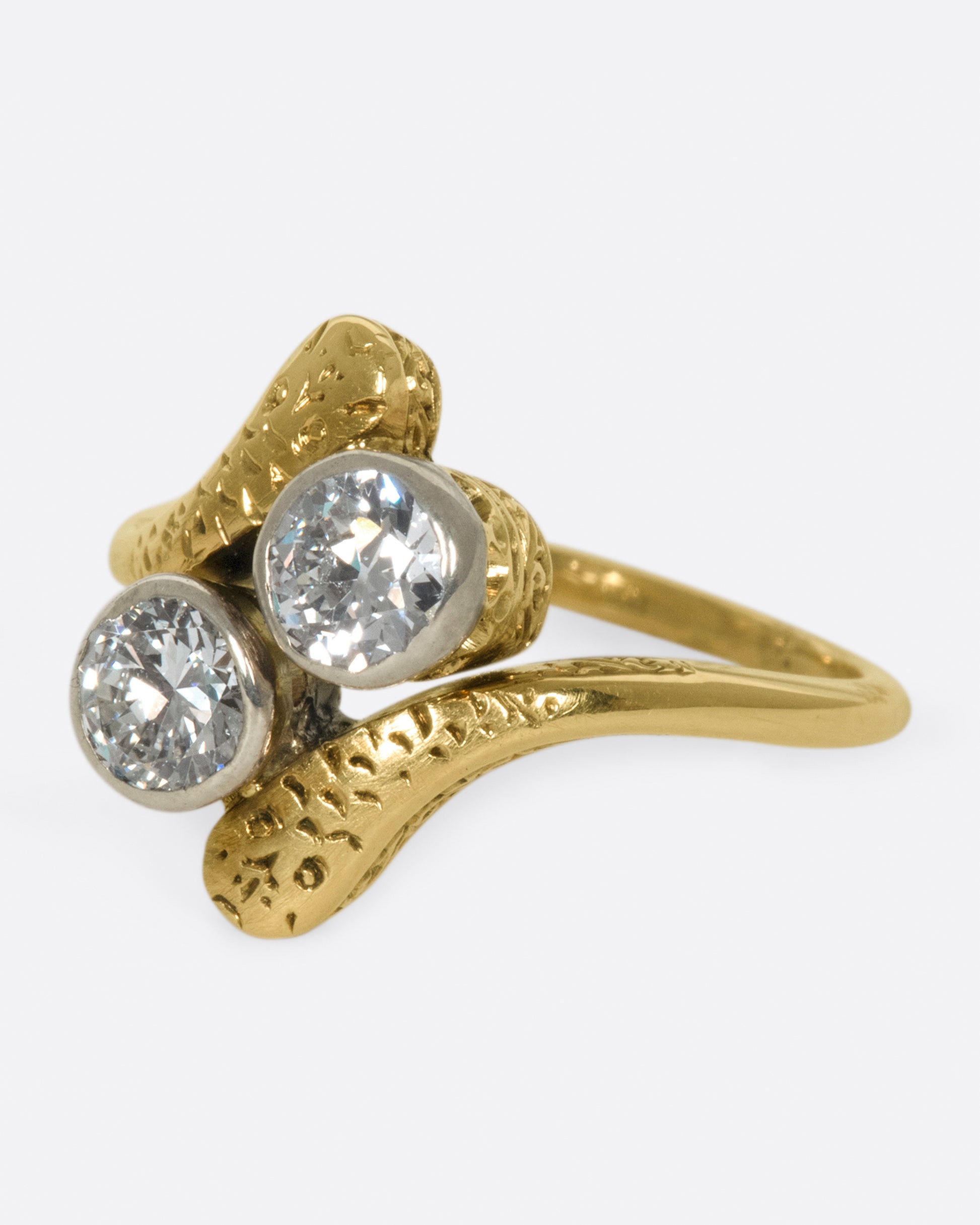 A vintage, Russian ring with two large old European cut diamonds at its center.