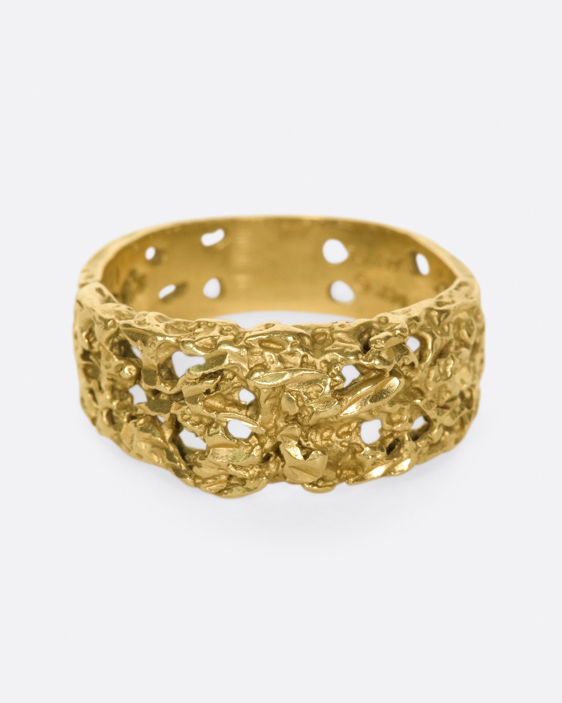 The cutouts on this ring almost look like the gold has eroded away, leaving little windows.