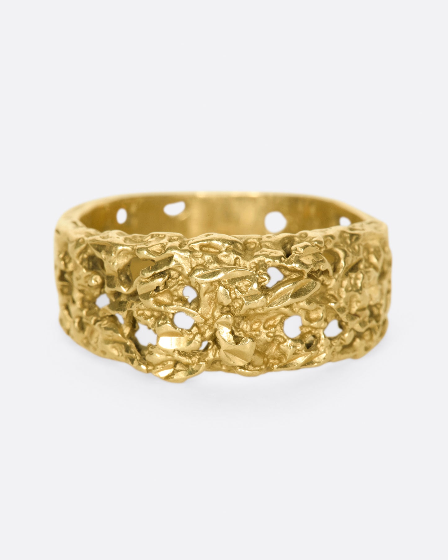 The cutouts on this ring almost look like the gold has eroded away, leaving little windows.